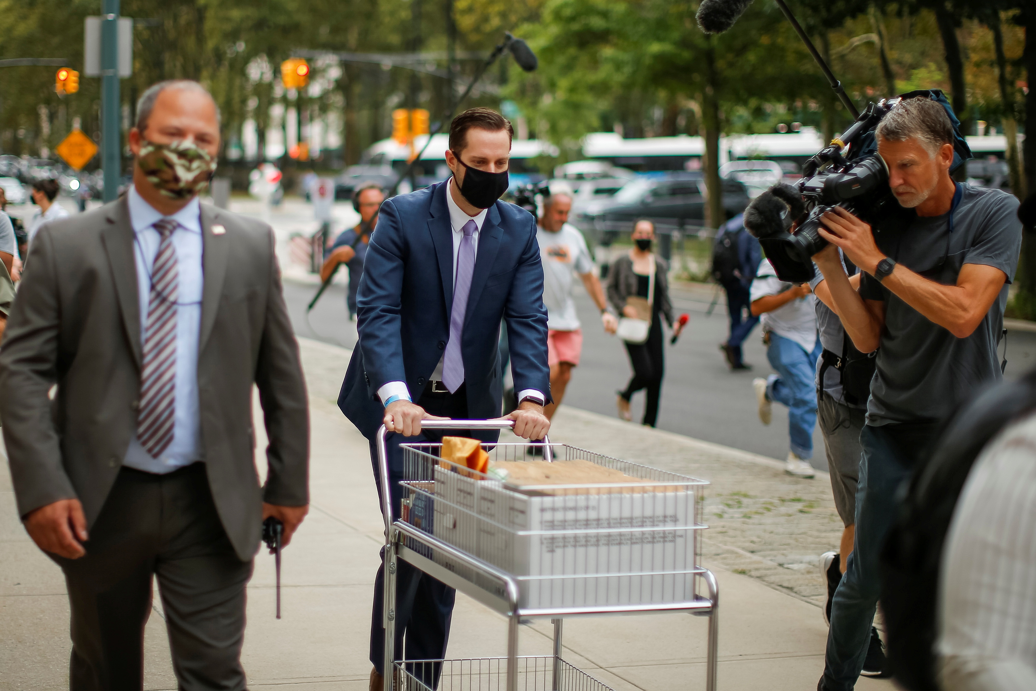 Prosecutors push a cart with documents related to R. Kelly's trial as they arrive to Brooklyn federal court in New York