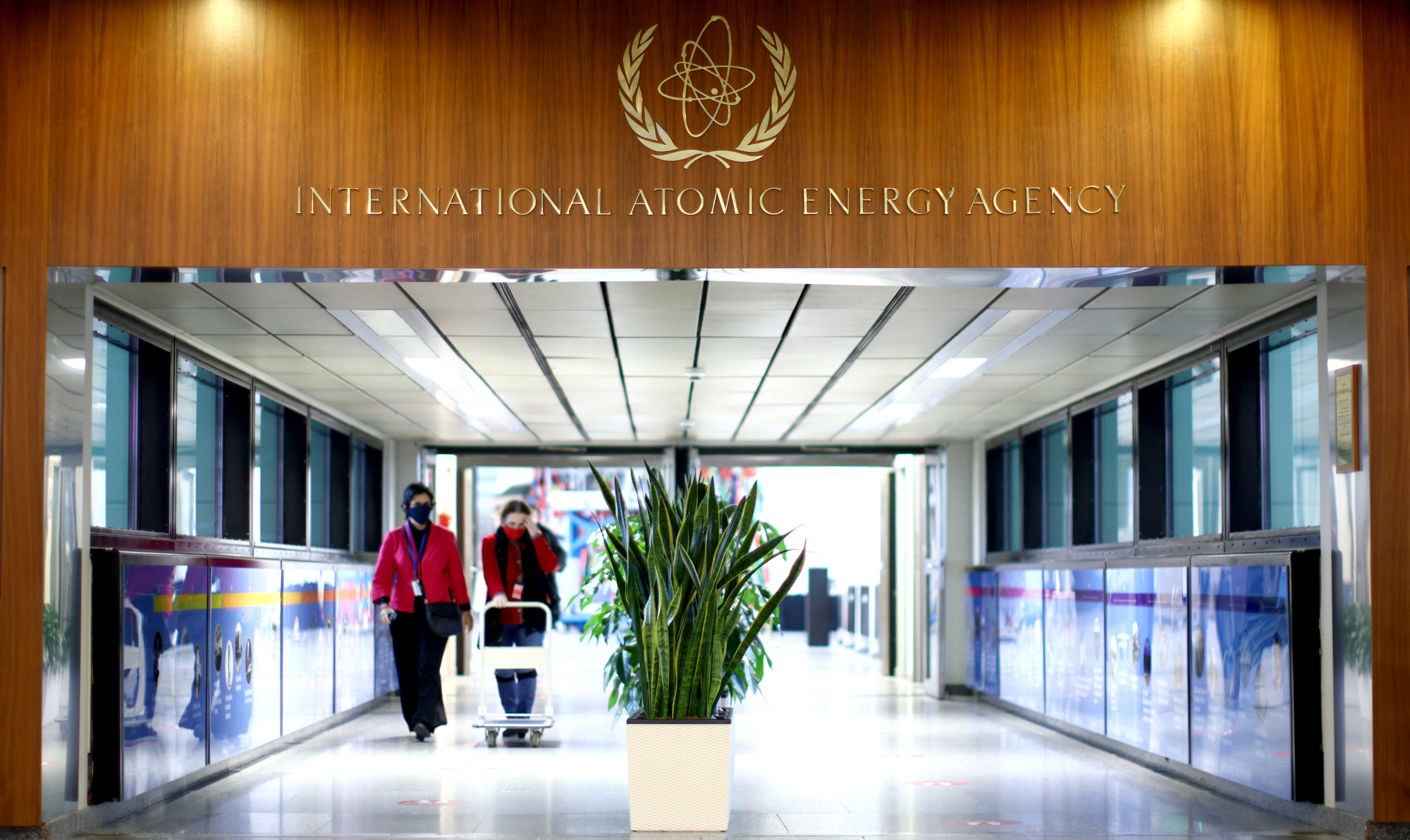 People walk along a corridor at the headquarters of the International Atomic Energy Agency (IAEA) in Vienna