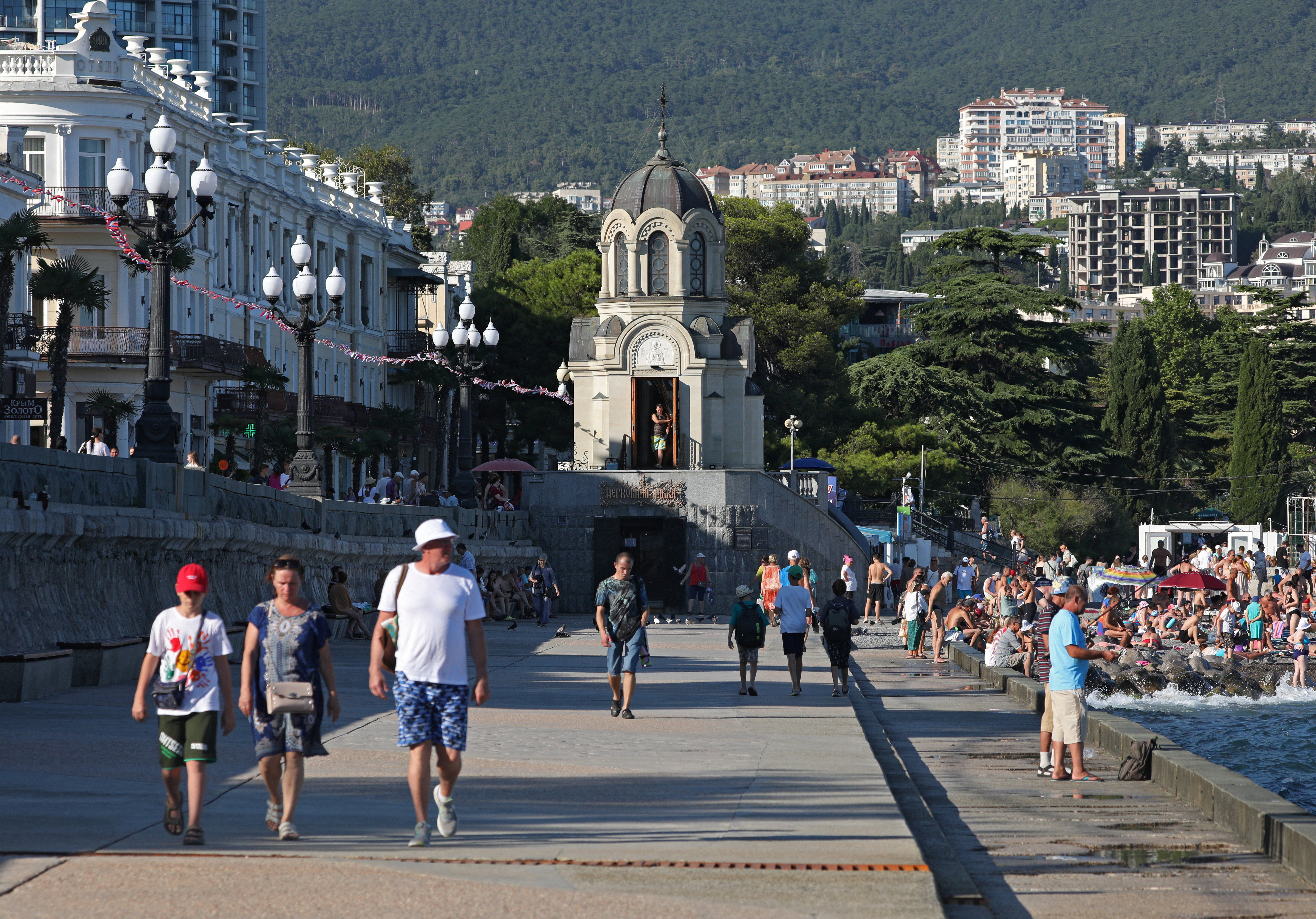 People walk along an embankment in Yalta