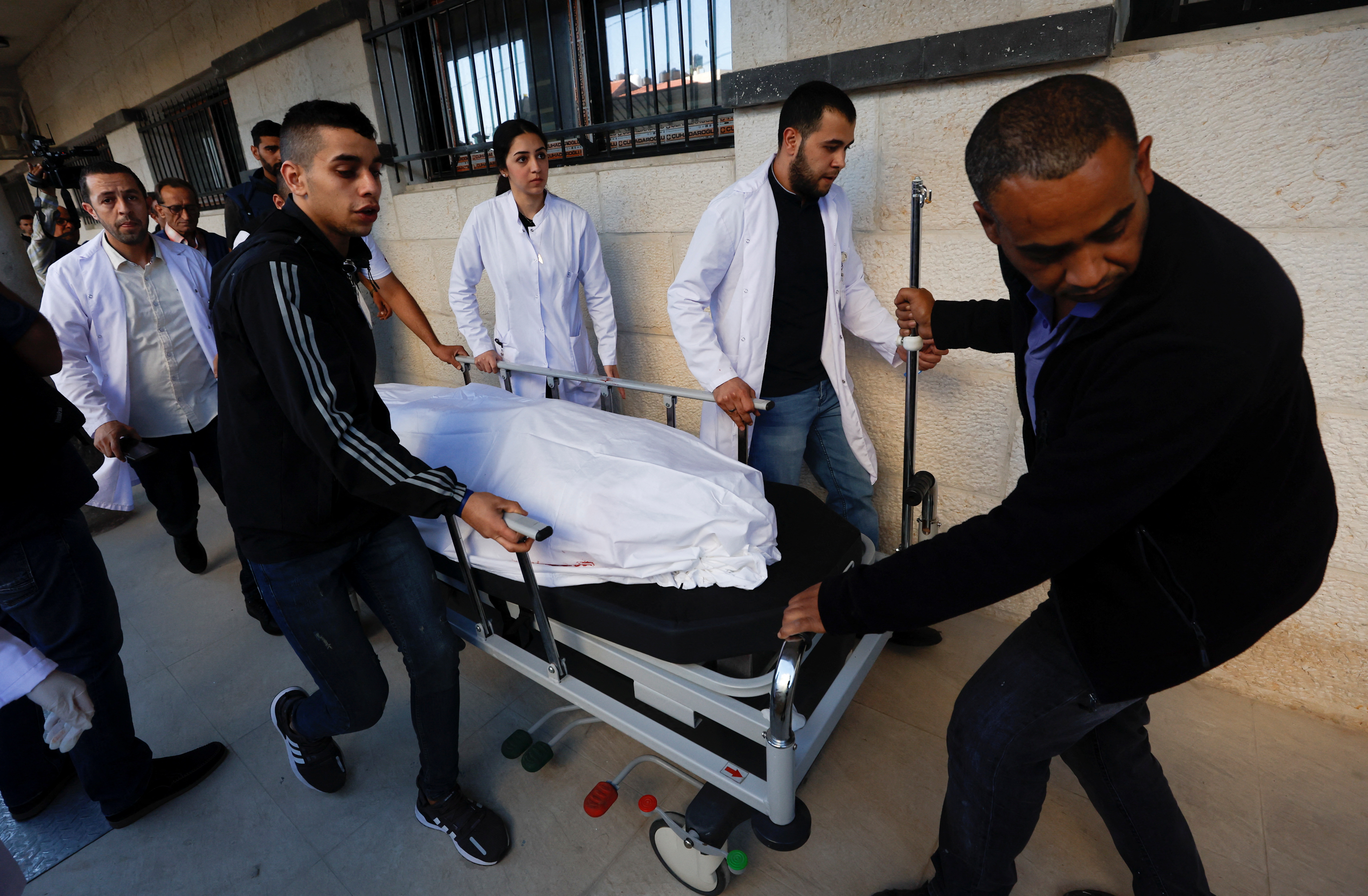 The body of Al Jazeera reporter Shireen Abu Akleh is carried on a stretcher at a hospital following an Israeli raid, in Jenin