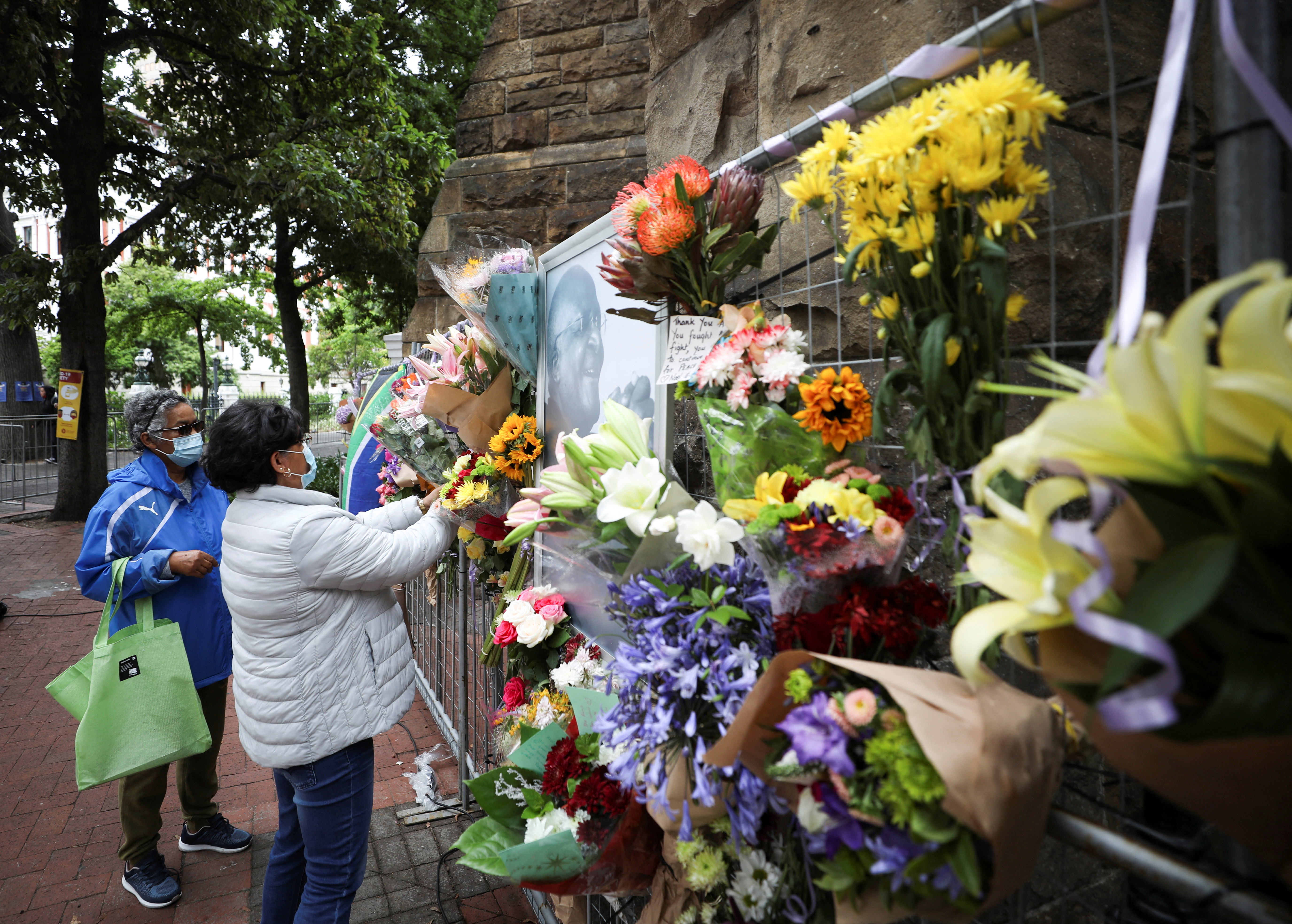 Mourners pay their respects to the late Archishop Desmond Tutu outside St Georges cathedral in Cape Town