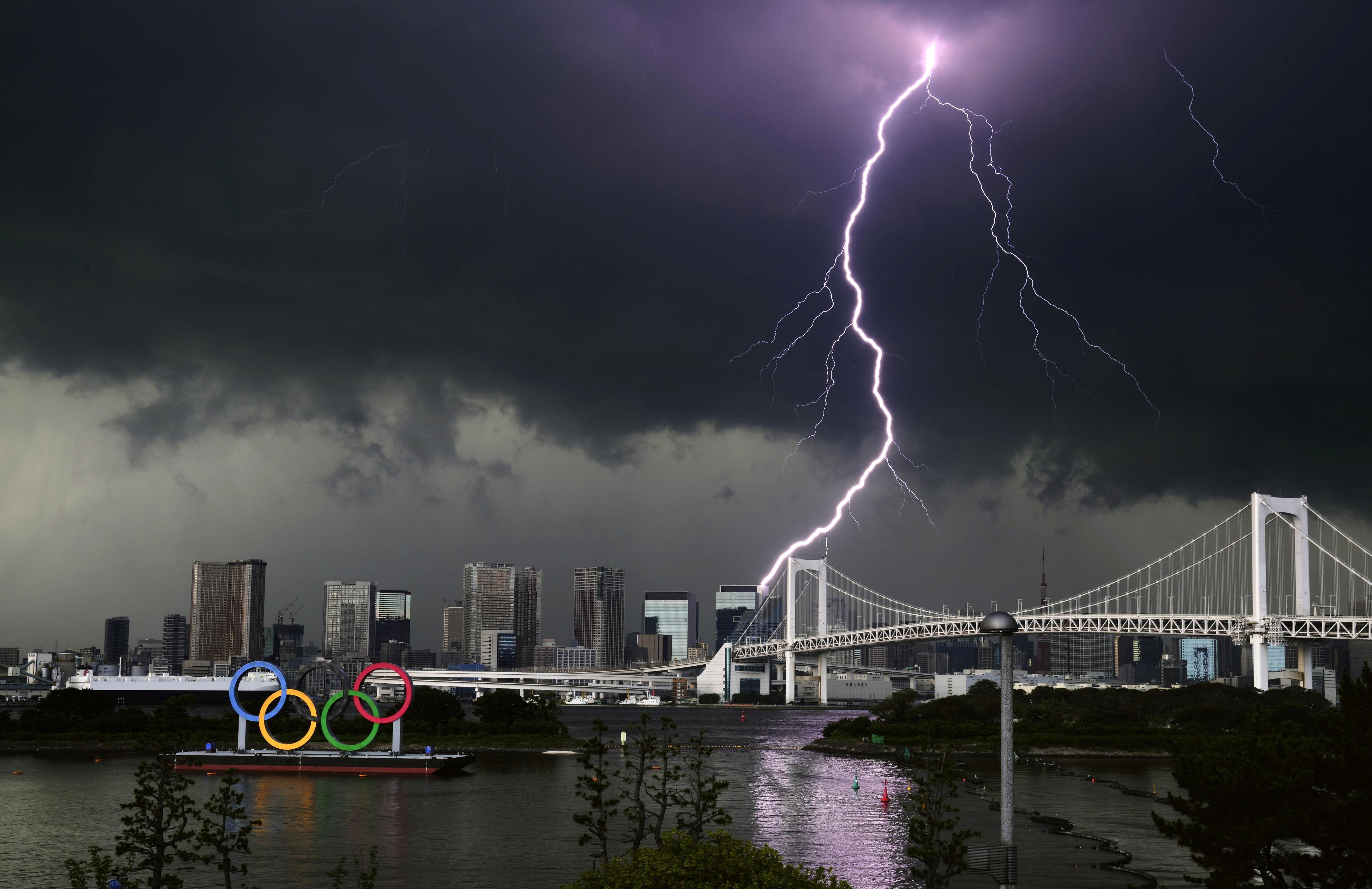 A lightening is seen over the giant Olympic rings and the Rainbow Bridge from the waterfront area of Odaiba Marine Park, ahead of the opening of the 2020 Tokyo Olympic Games, that have been postponed to 2021 due to the coronavirus disease (COVID-19) outbreak, in Tokyo, Japan July 11, 2021. Mandatory credit Kyodo/via REUTERS