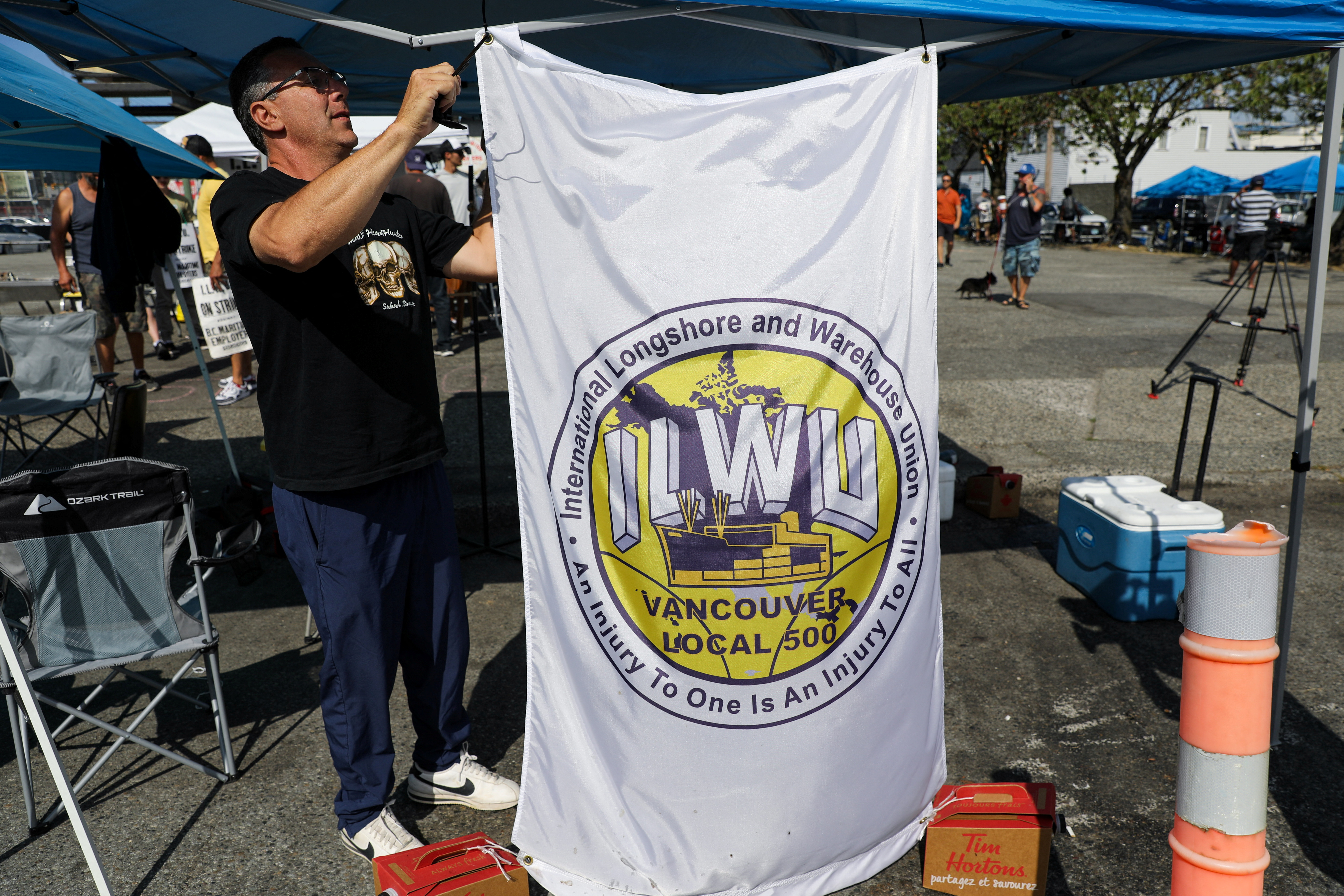 Union members with the International Longshore and Warehouse Union Canada (ILWU) gather, in Vancouver