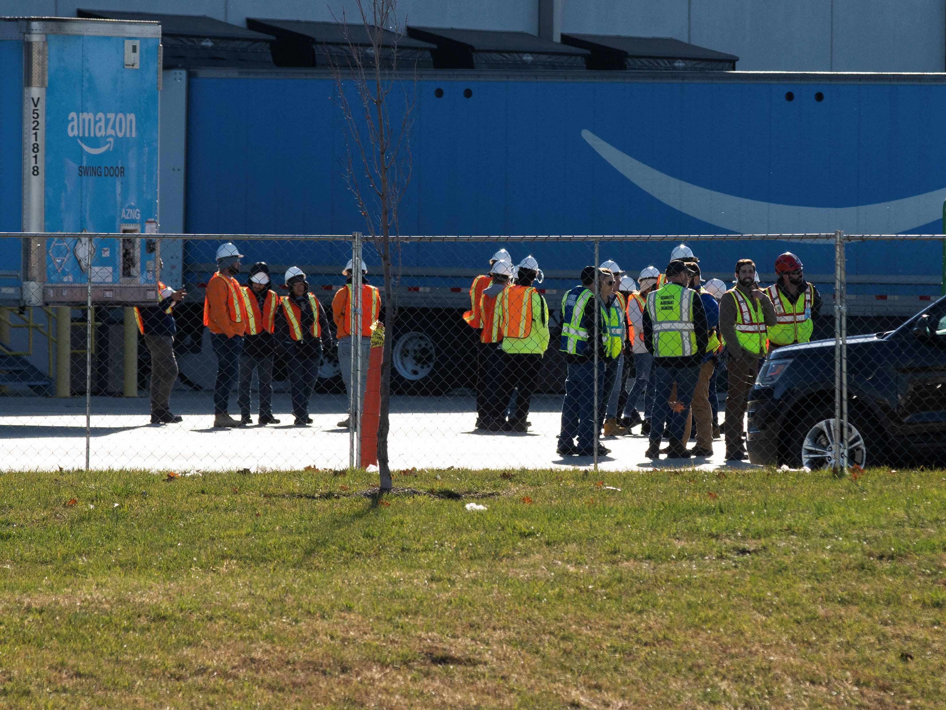 Emergency vehicles surround the site of a roof collapse at an Amazon distribution center in Edwardsville