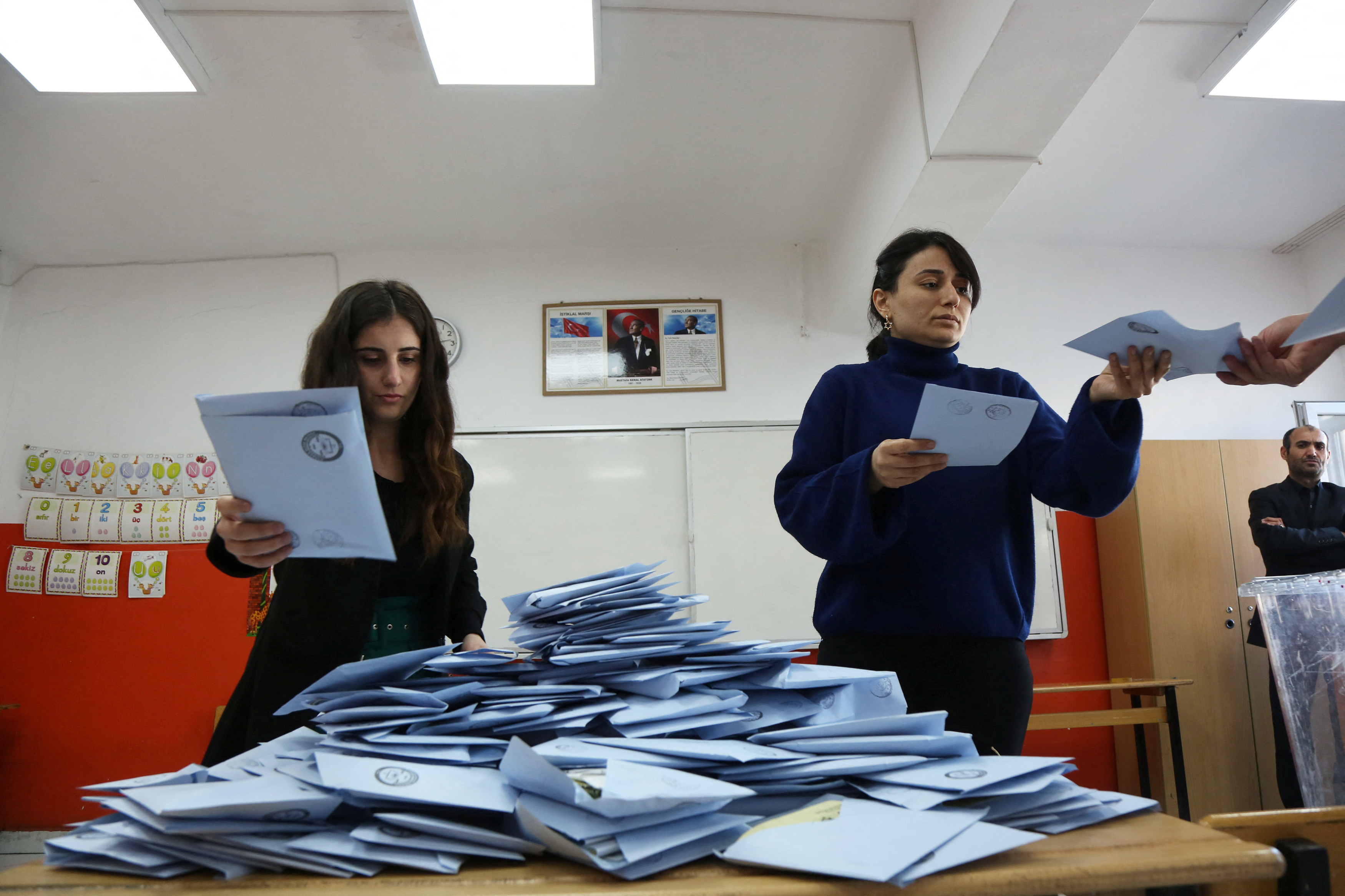 Election officials count ballots at a polling station during the local elections in Diyarbakir
