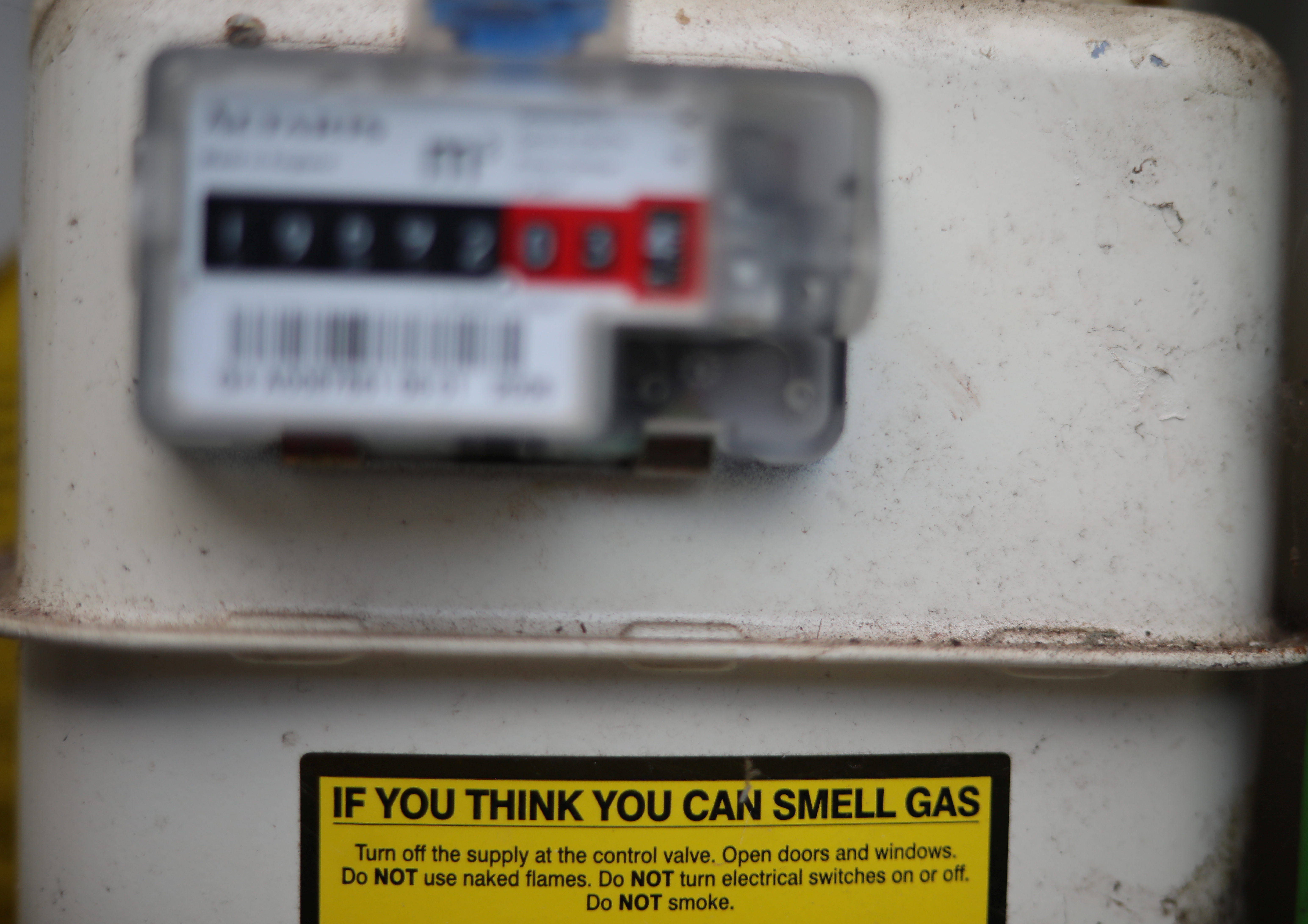 A warning label is seen on the front of a gas meter at a house in Manchester