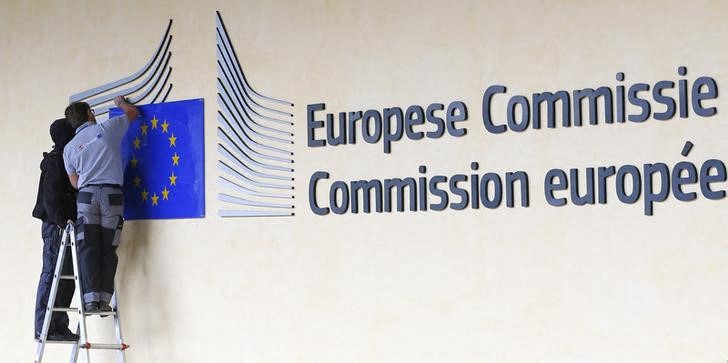 Worker adjust and clean the logo of the European Commission at the entrance of the EC headquarters in Brussels