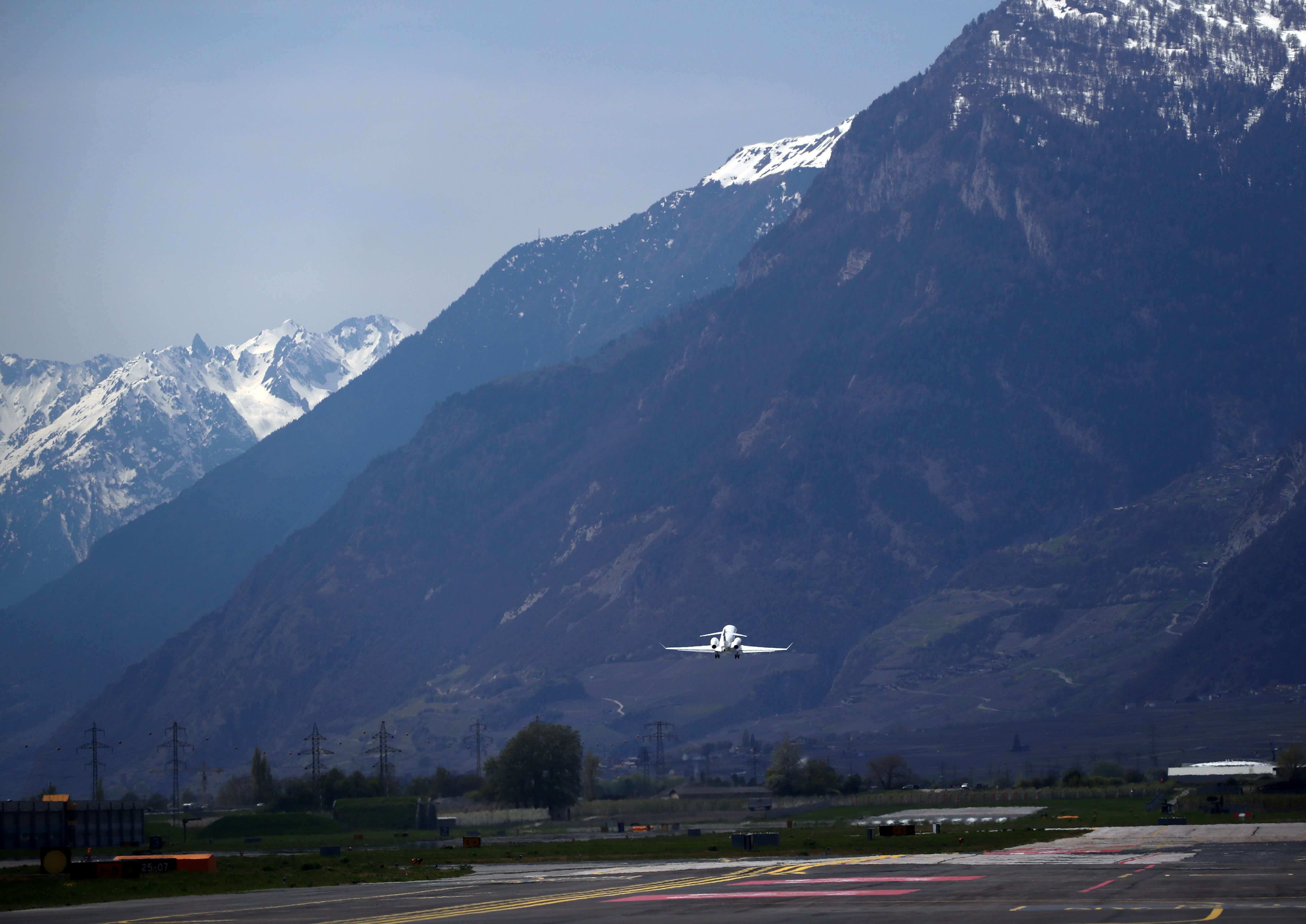 A Bombardier BD-100-1A10 Challenger 350 aircraft (Registration CS-CHE) of NetJets Europe takes off from Sion airport in Sion, Switzerland April 18, 2019. REUTERS/Denis Balibouse 