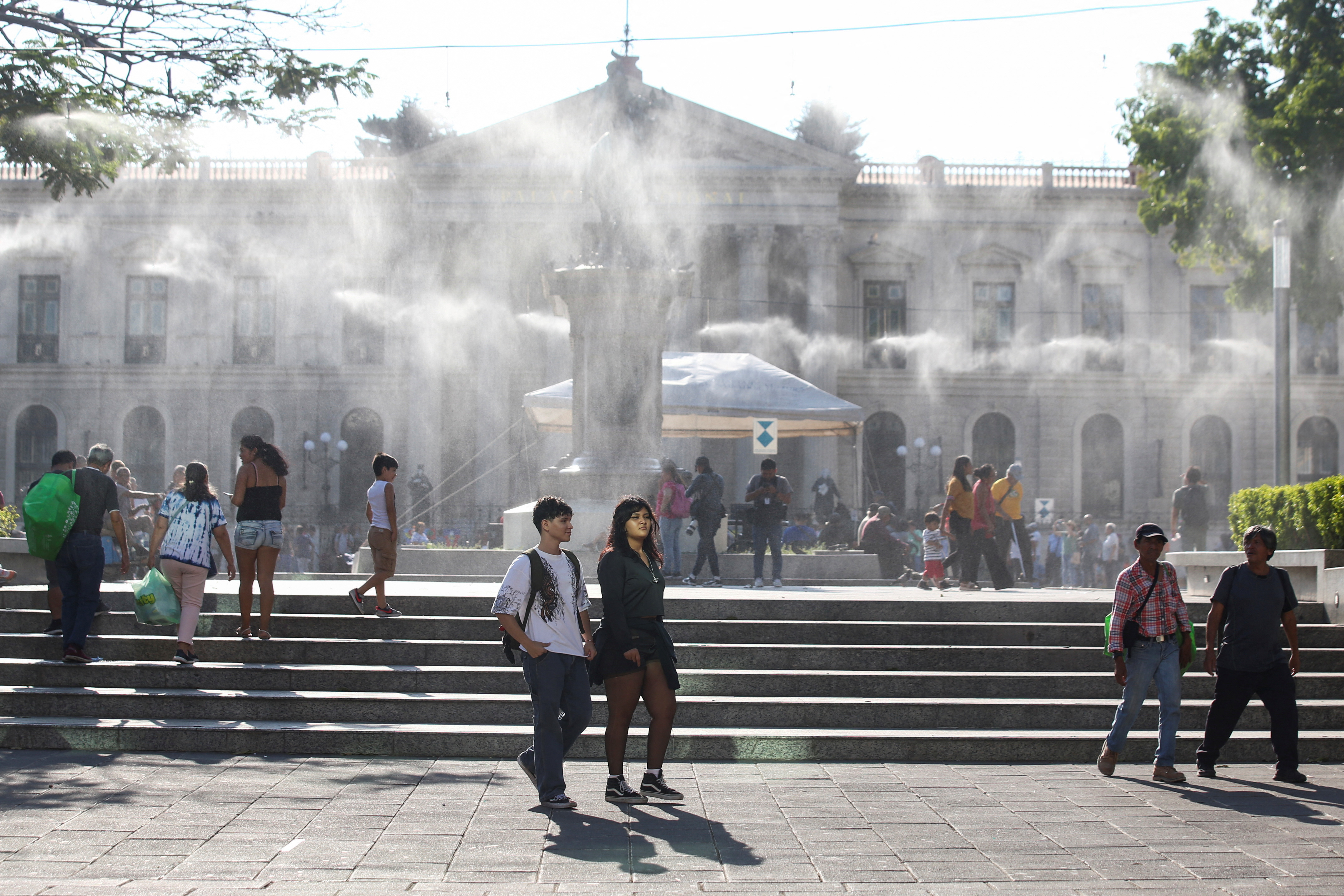 Water is sprayed by a system to alleviate the high temperatures, in San Salvador
