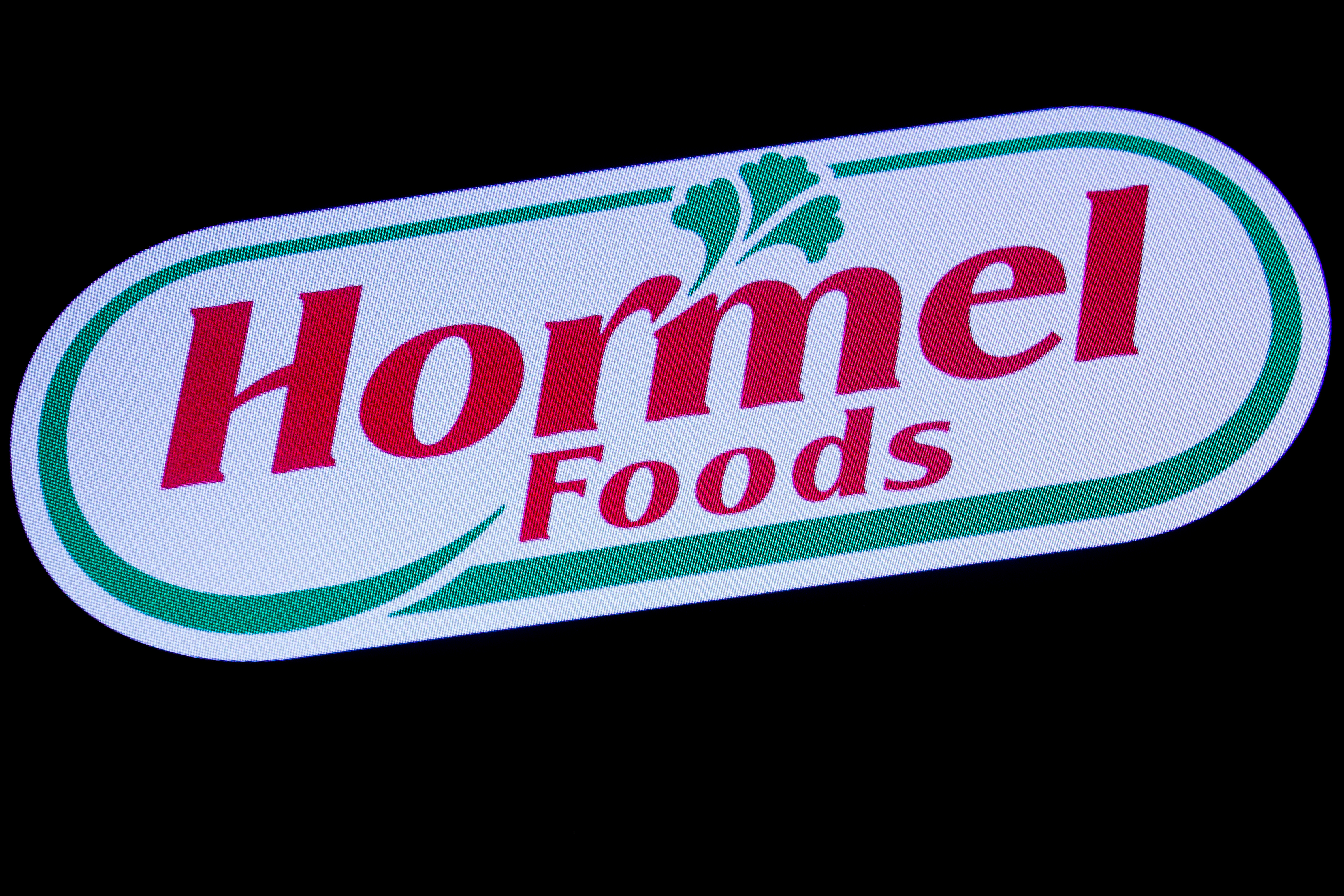 The company logo for Hormel Foods is displayed on a screen on the floor at the NYSE in New York
