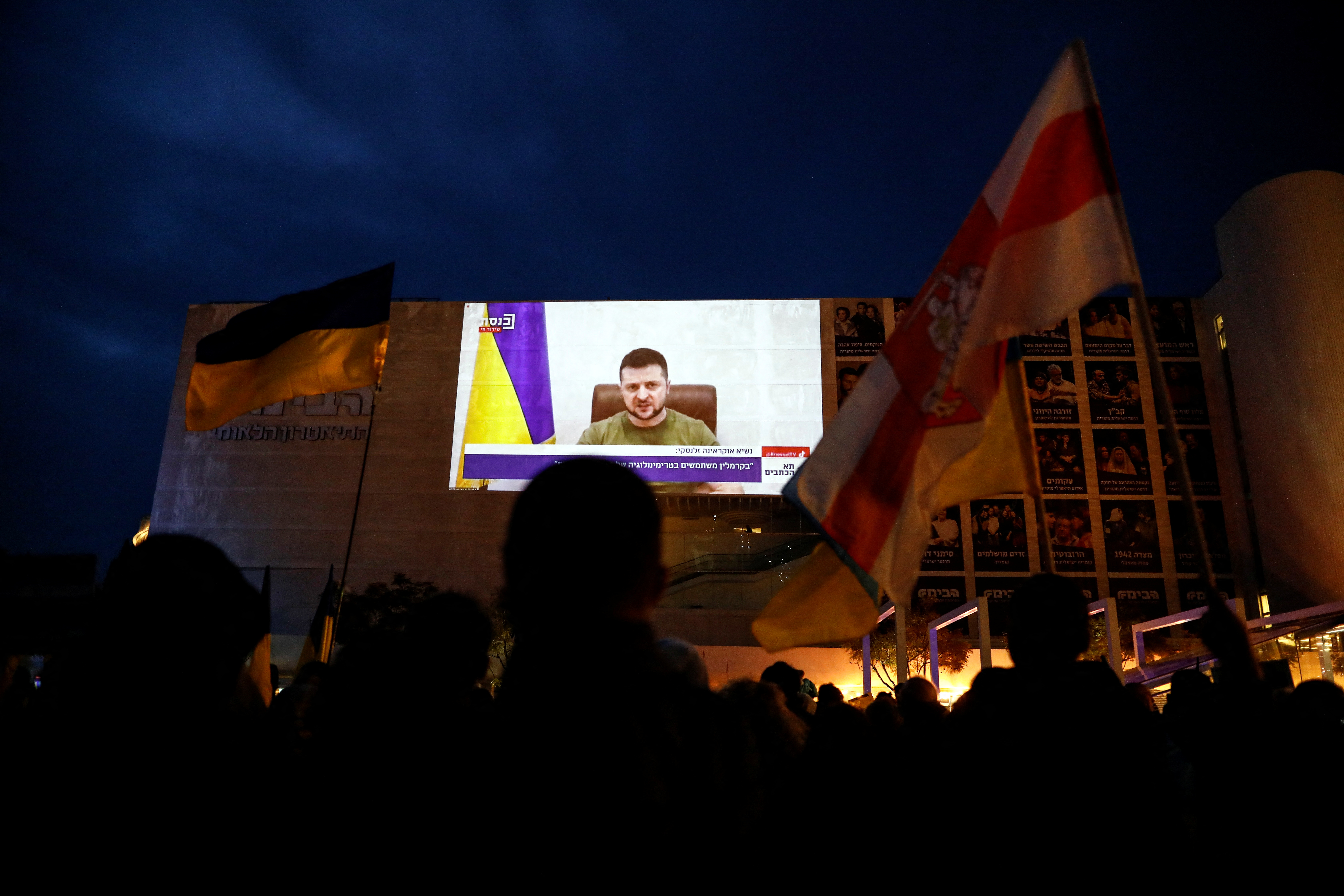 A broadcast of Zelenskiy speech to the Knesset, Israel's parliament is shown in Tel Aviv