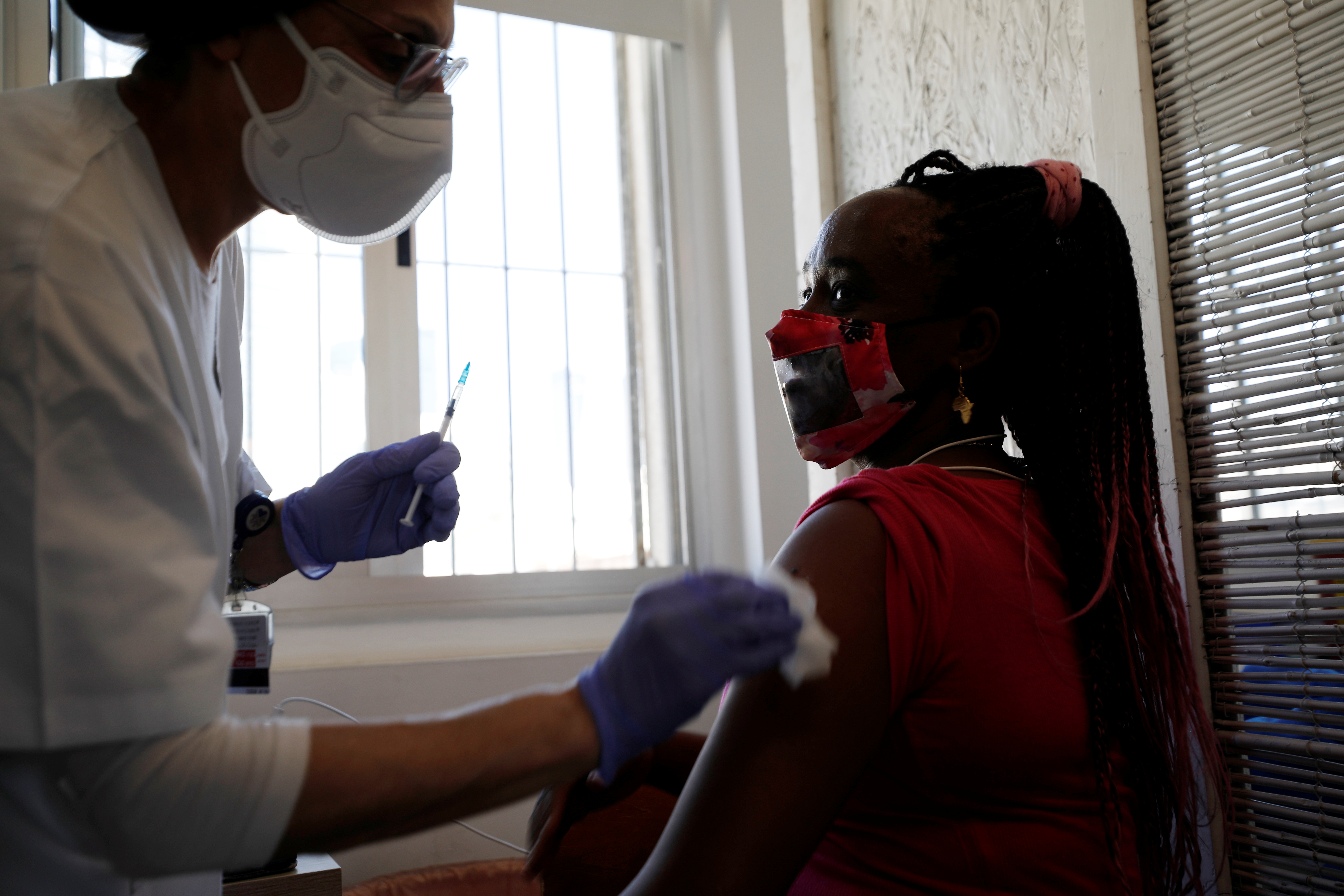 A medical worker administers a vaccination against the coronavirus disease (COVID-19) at a newly-opened centre in a neighbourhood with a high residency of foreign nationals, including migrant workers, in Tel Aviv