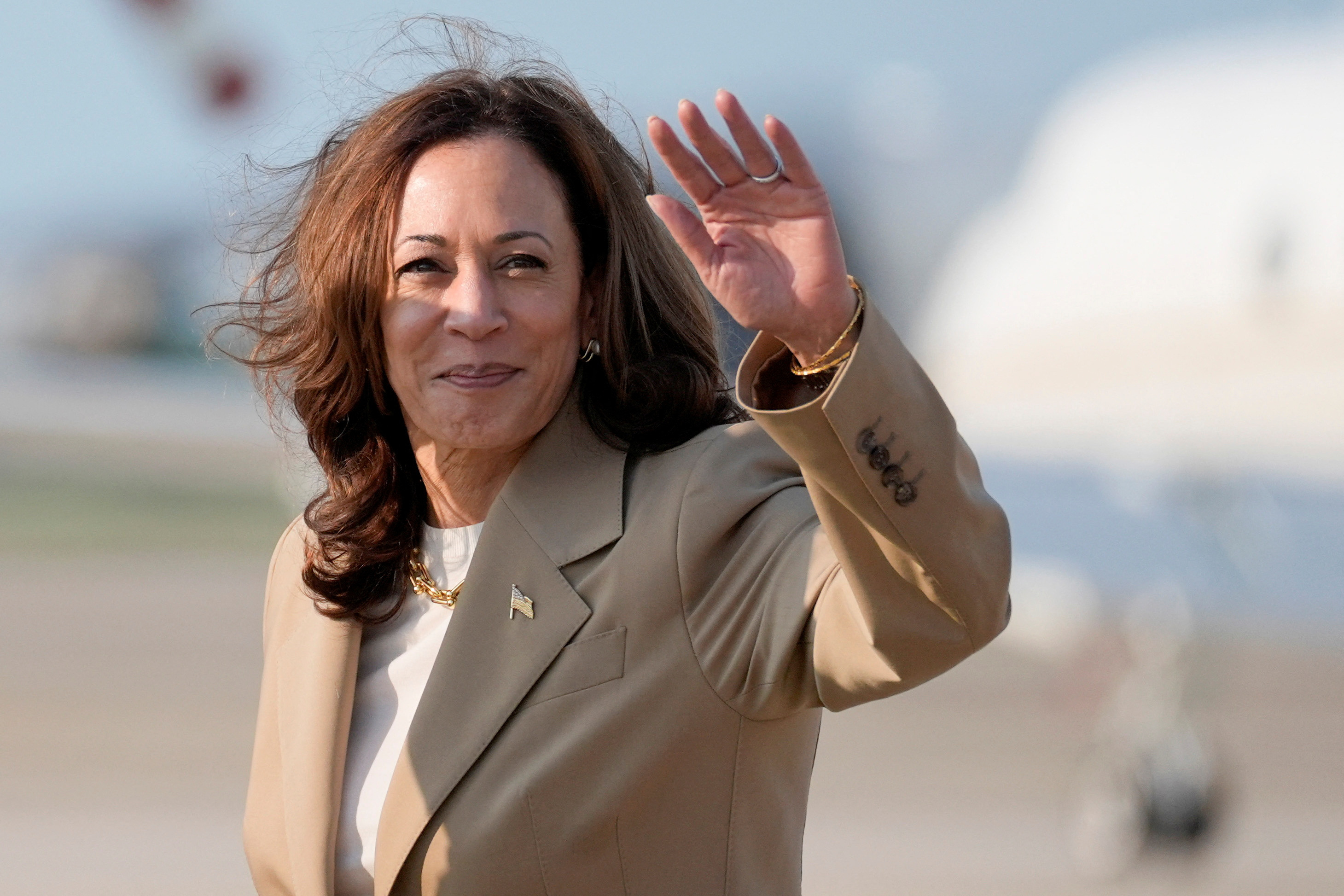 U.S. Vice President Kamala Harris waves upon arrival at Joint Base Andrews