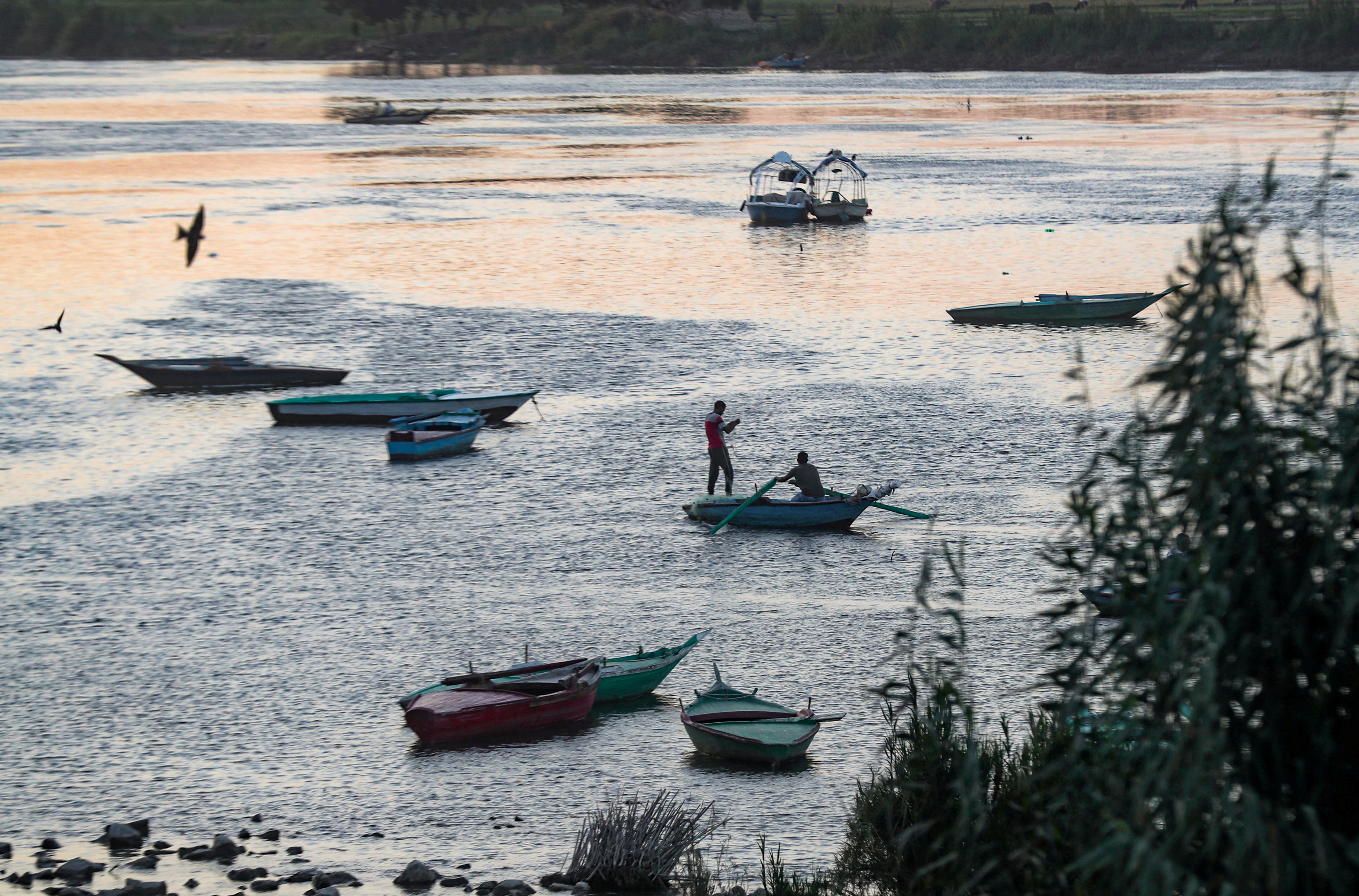 Fishermen are seen on a boat on the Nile River on the outskirts of Cairo, following the outbreak of the coronavirus disease (COVID-19)