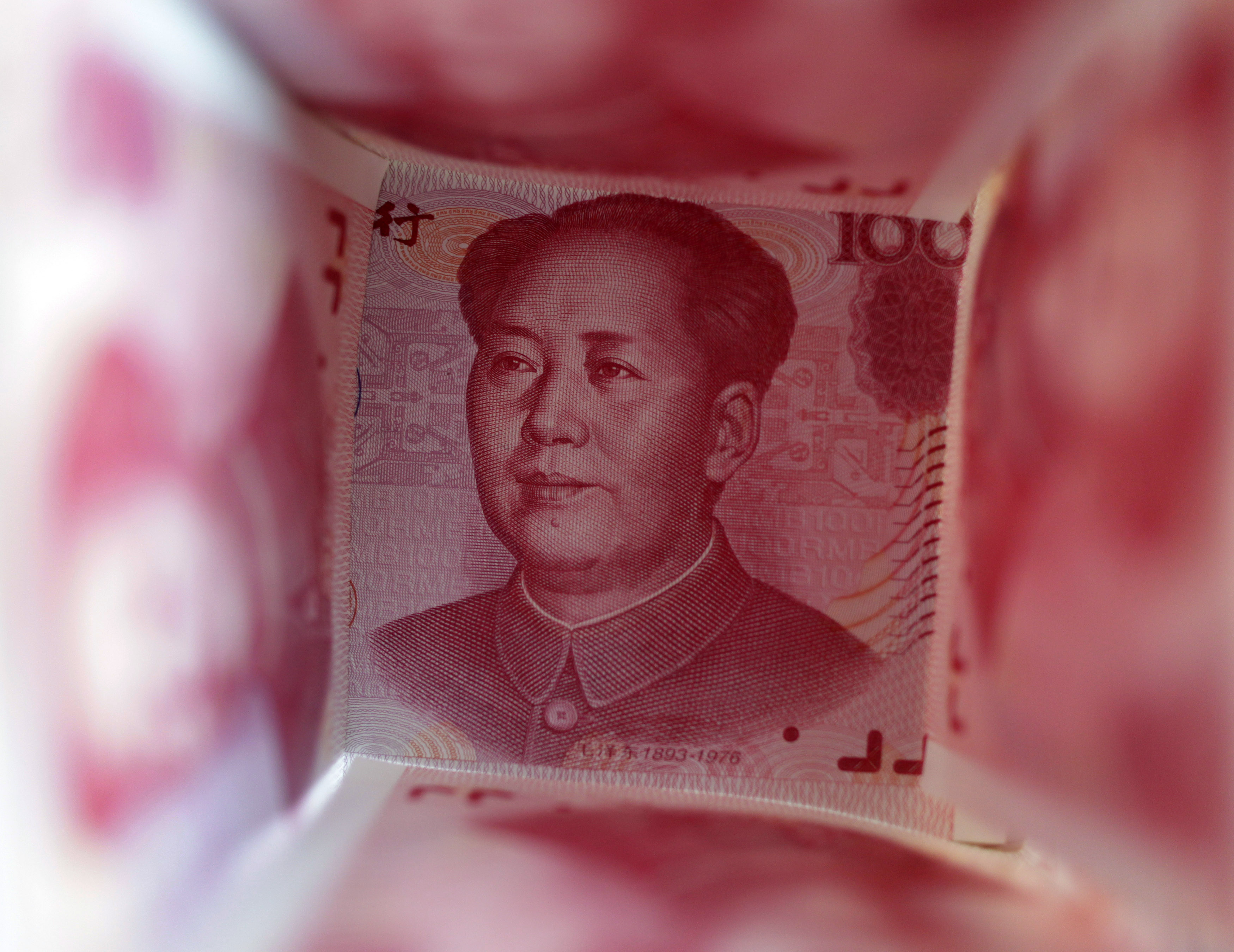 A 100 Yuan note is surrounded by other 100 Yuan notes in this picture illustration in Beijing