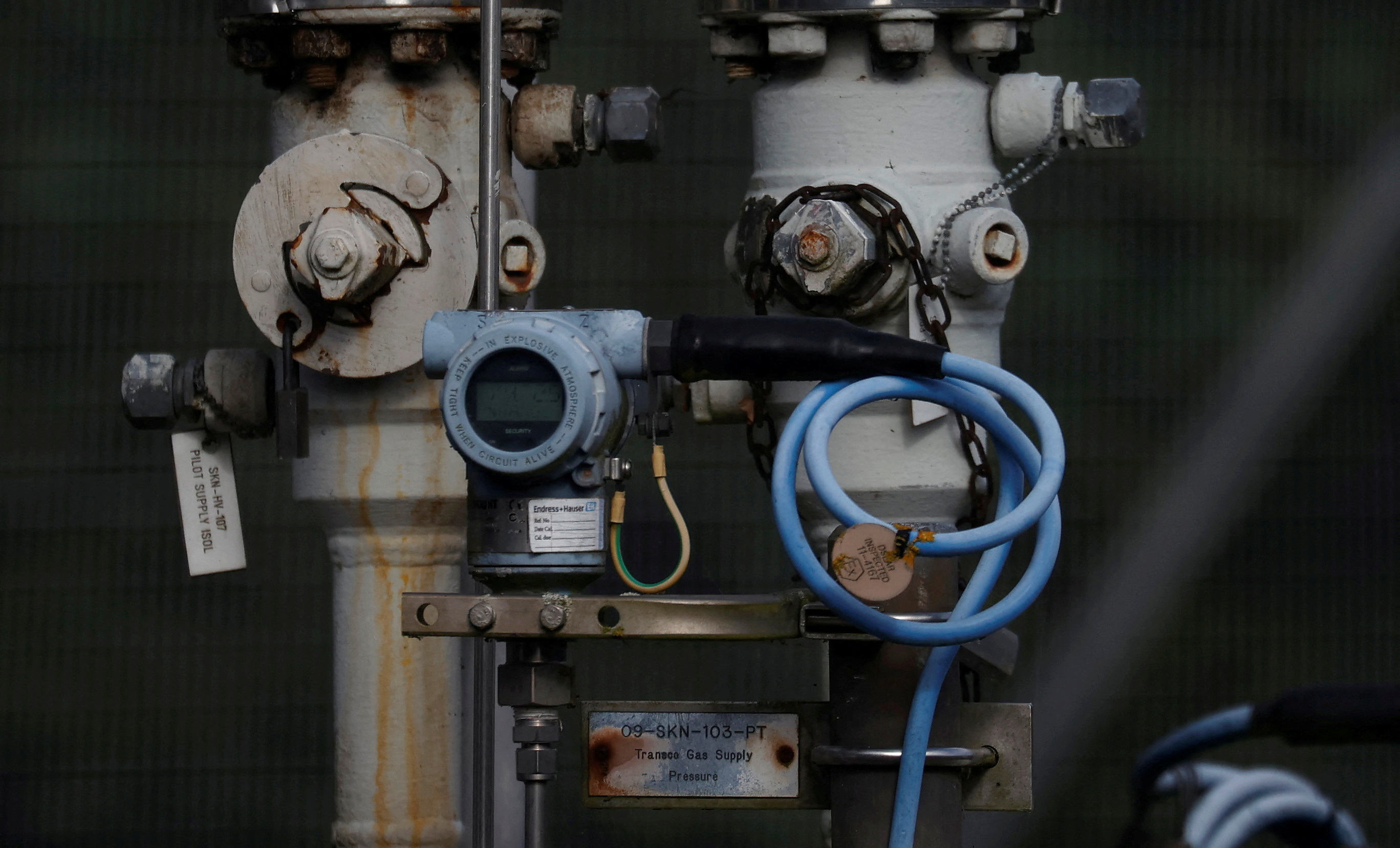 Dials and valves are seen near a section of gas pipeline at a National Grid facility near Knutsford