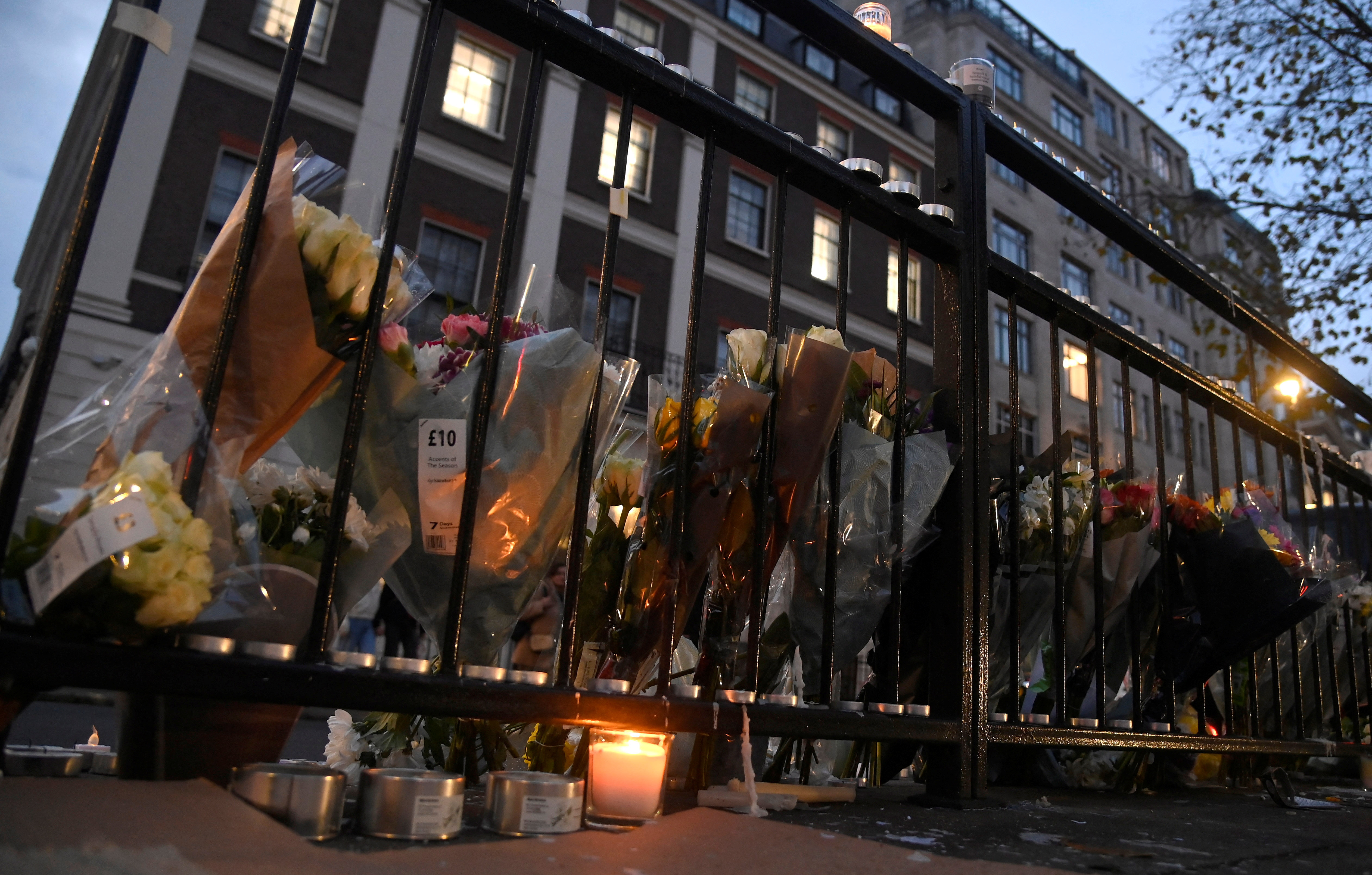 Flowers and candles placed opposite Chinese Embassy in London
