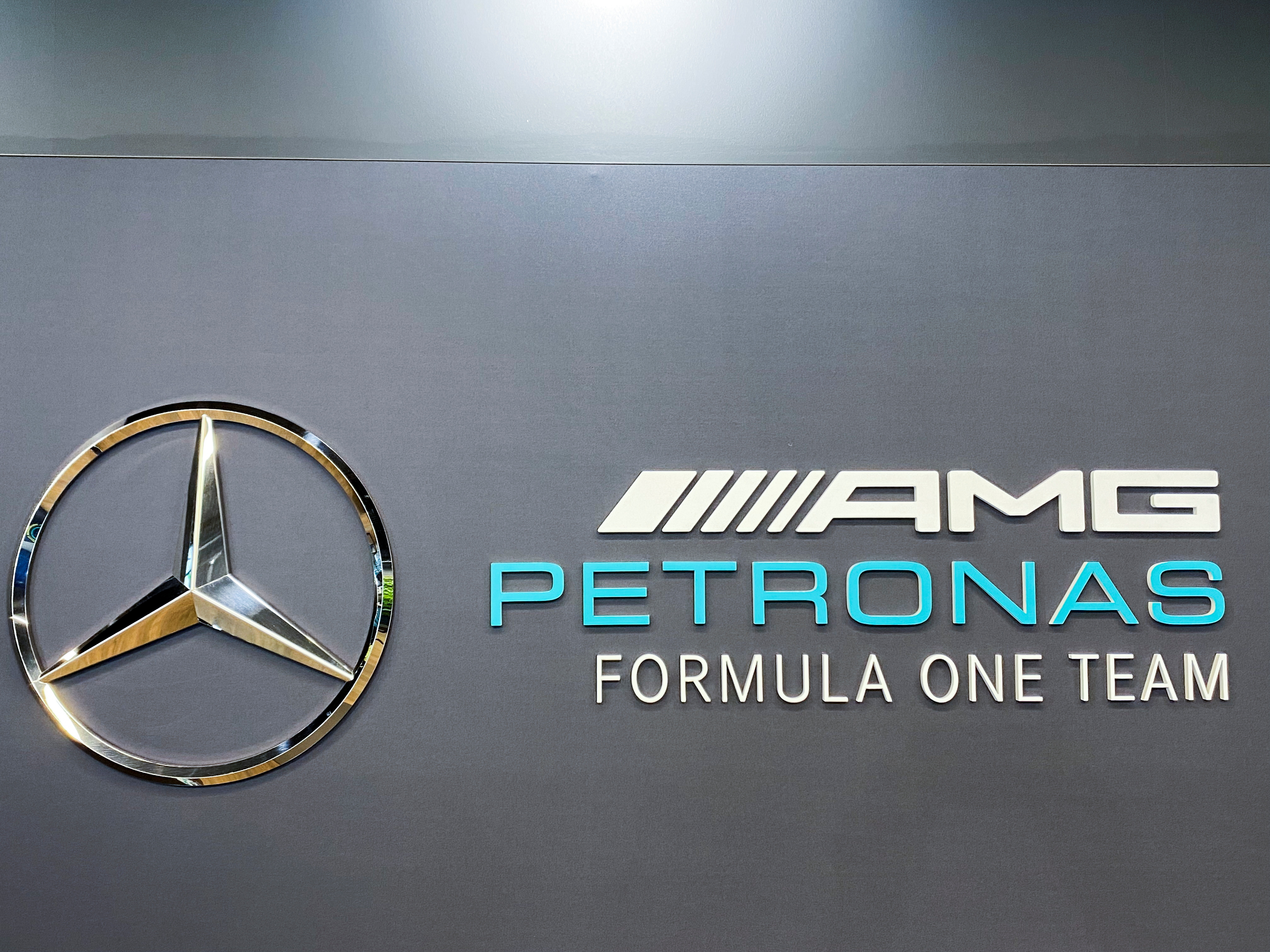 Mercedes-AMG Petronas Formula One team logo is displayed at the launch of the INEOS Britannia America's Cup challenge in Brackley