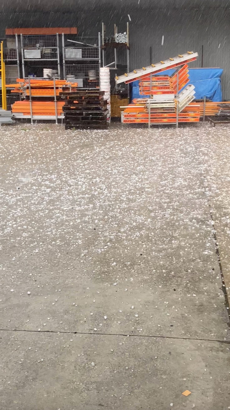 Huge hailstones pelt into a garage in Gold Coast, Queensland, Australia October 19, 2021, in this still image obtained from video. Courtesy of Greg Hateley / Social Media via REUTERS 