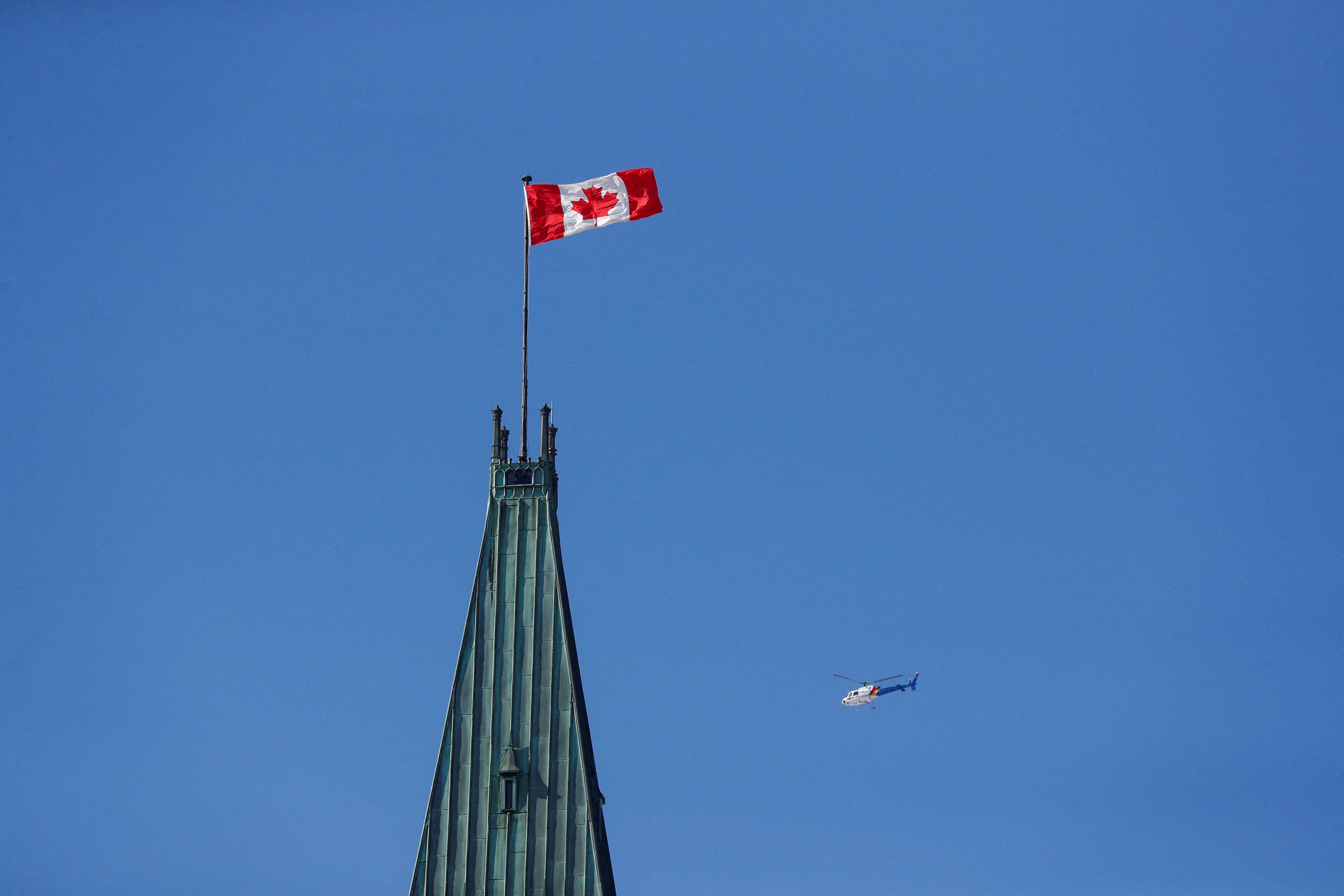 RCMP helicopter flies past the Peace Tower on Parliament Hill in Ottawa