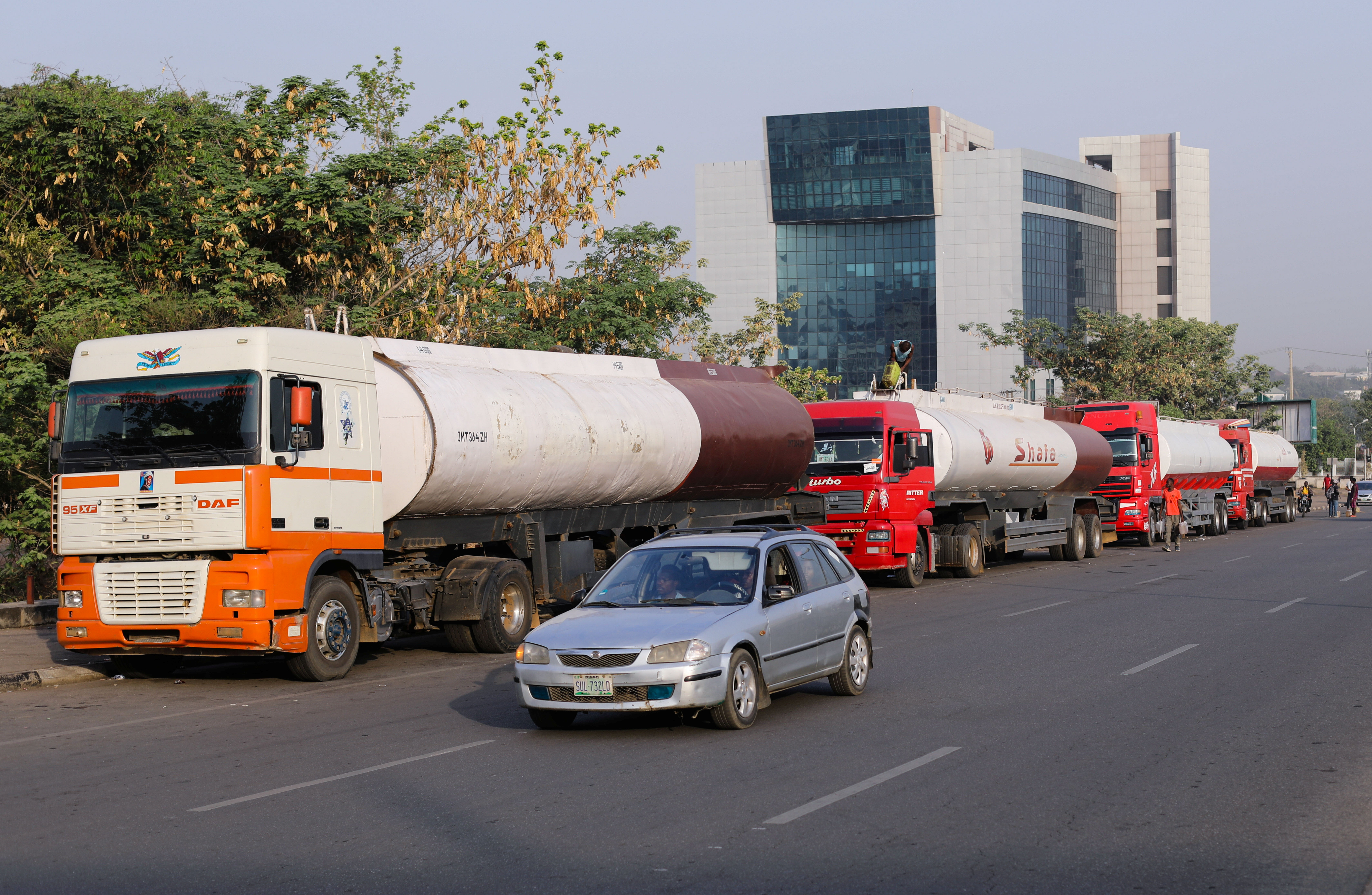 Trucks carry fresh supply of petrol along the Herbert Macaulay street in Abuja
