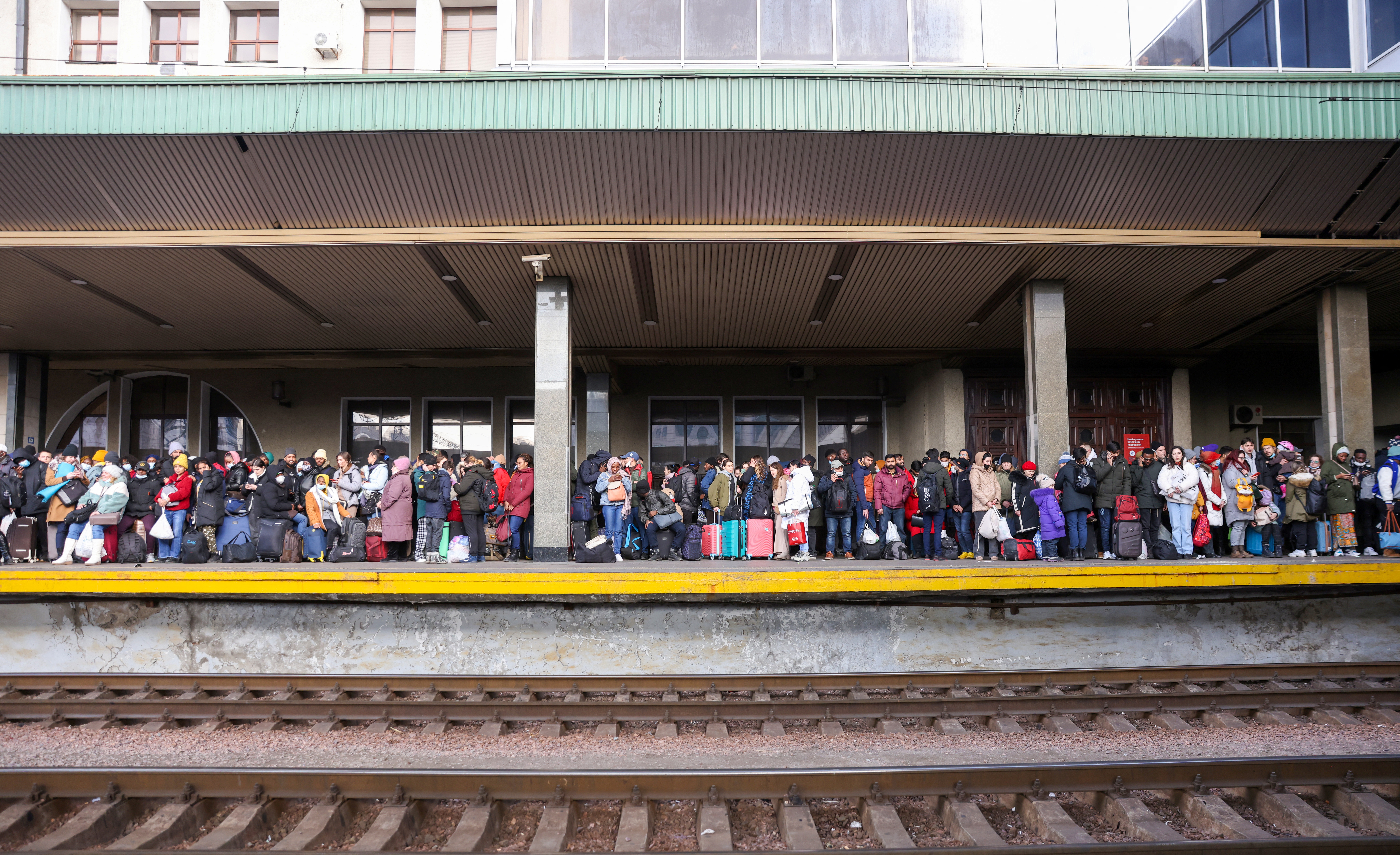 People wait to board a evacuaition train from Kyiv to Lviv at Kyiv central train station