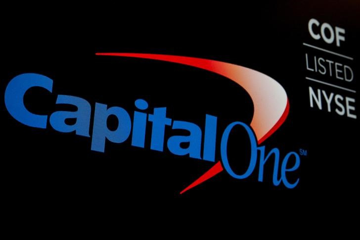 The logo and ticker for Capital One are displayed on a screen on the floor of the NYSE in New York