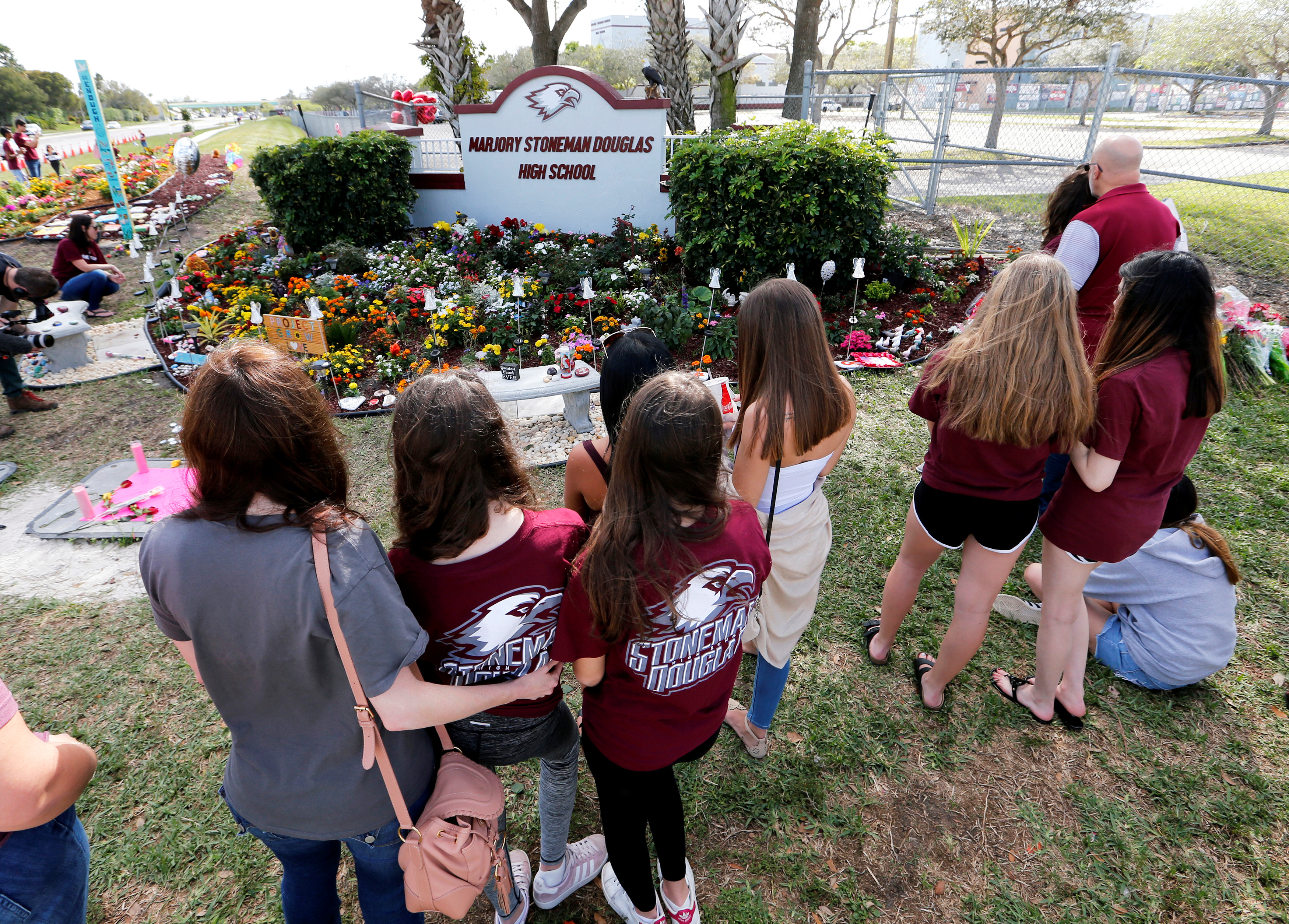 A memorial is viewed by parents and students on campus at a memorial on the one year anniversary of the shooting which claimed 17 lives at Marjory Stoneman Douglas High School in Parkland
