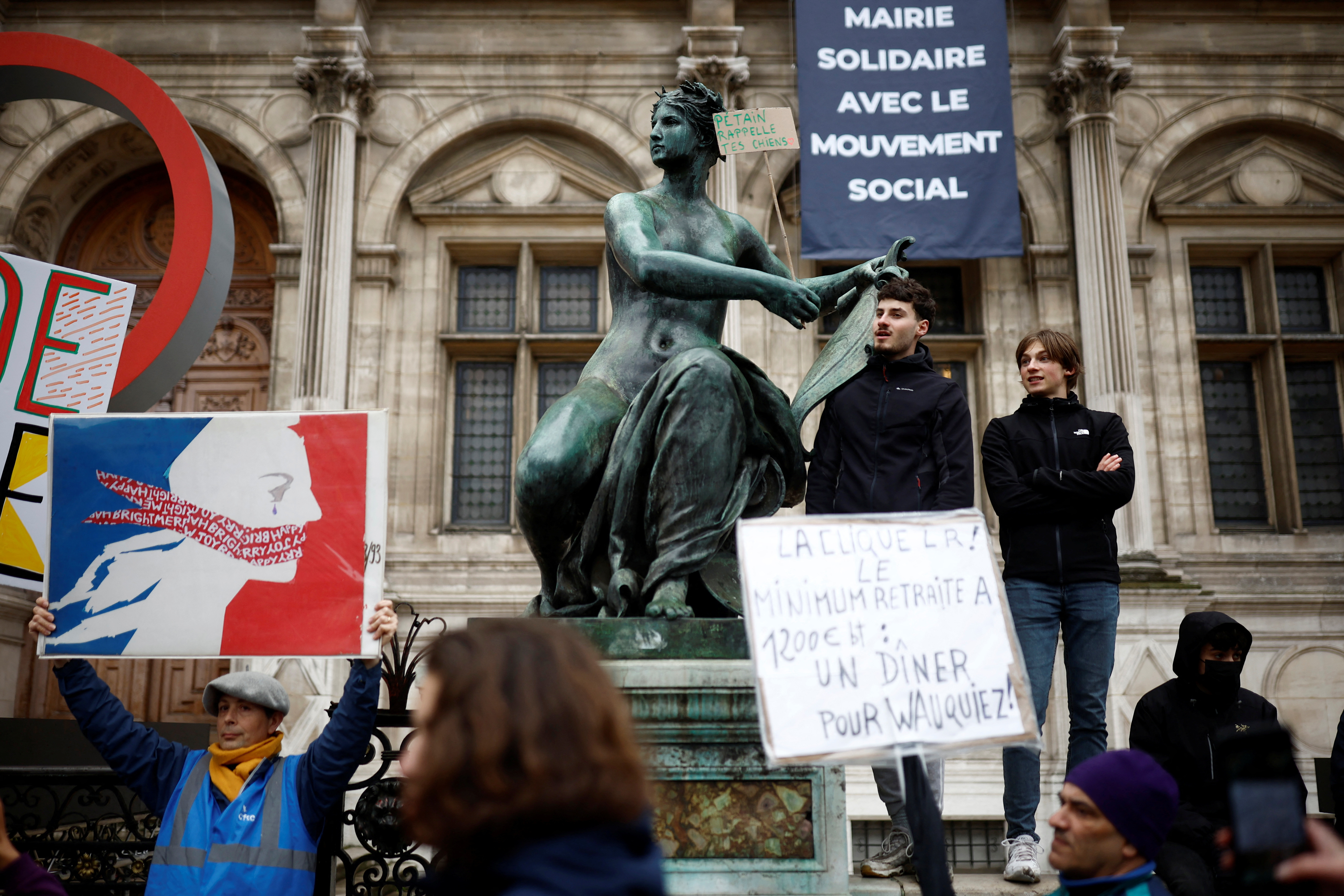 People attend a protest after Constitutional Council decision on pension reform in Paris