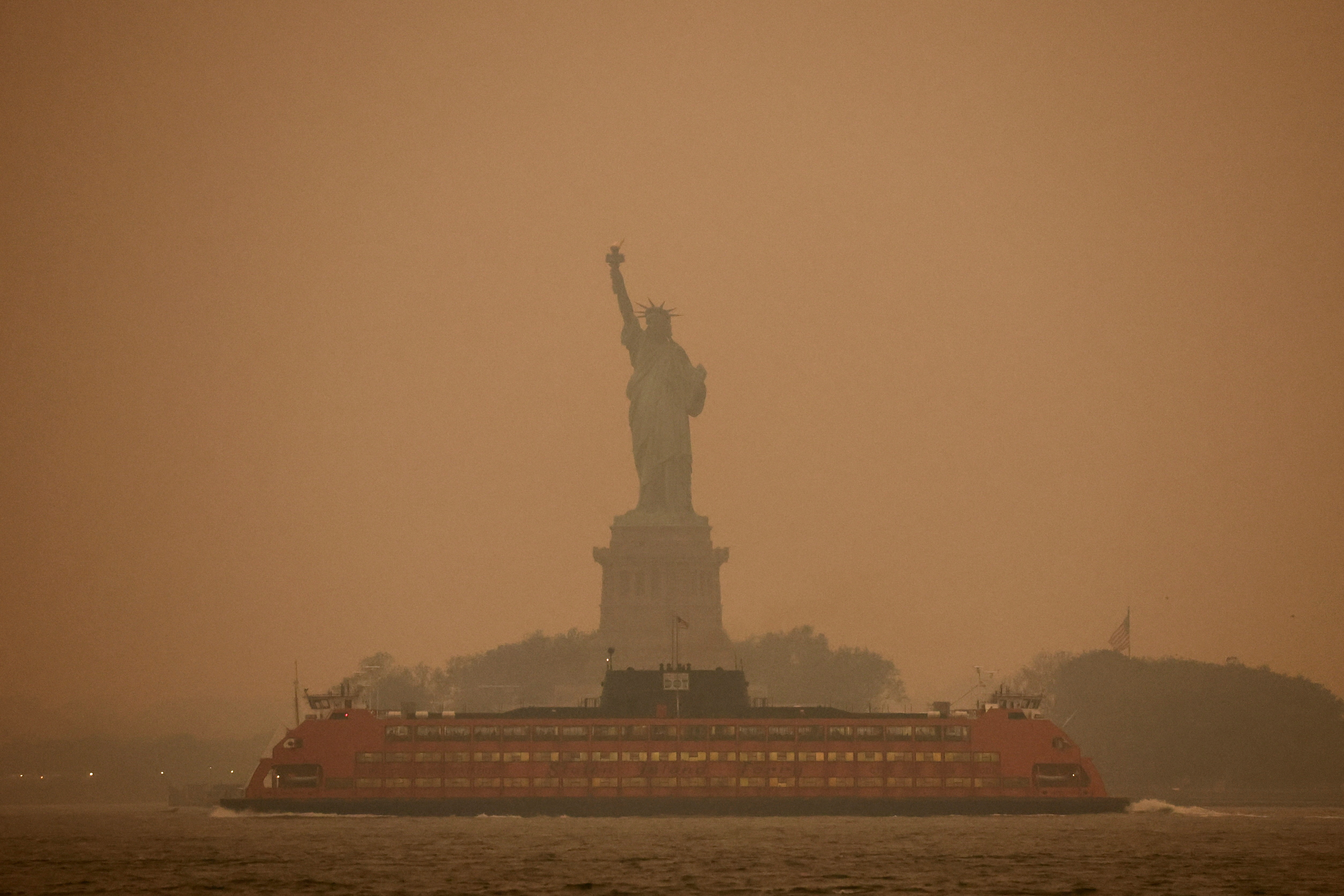 The Statue of Liberty is covered in haze and smoke caused by wildfires in Canada, in New York