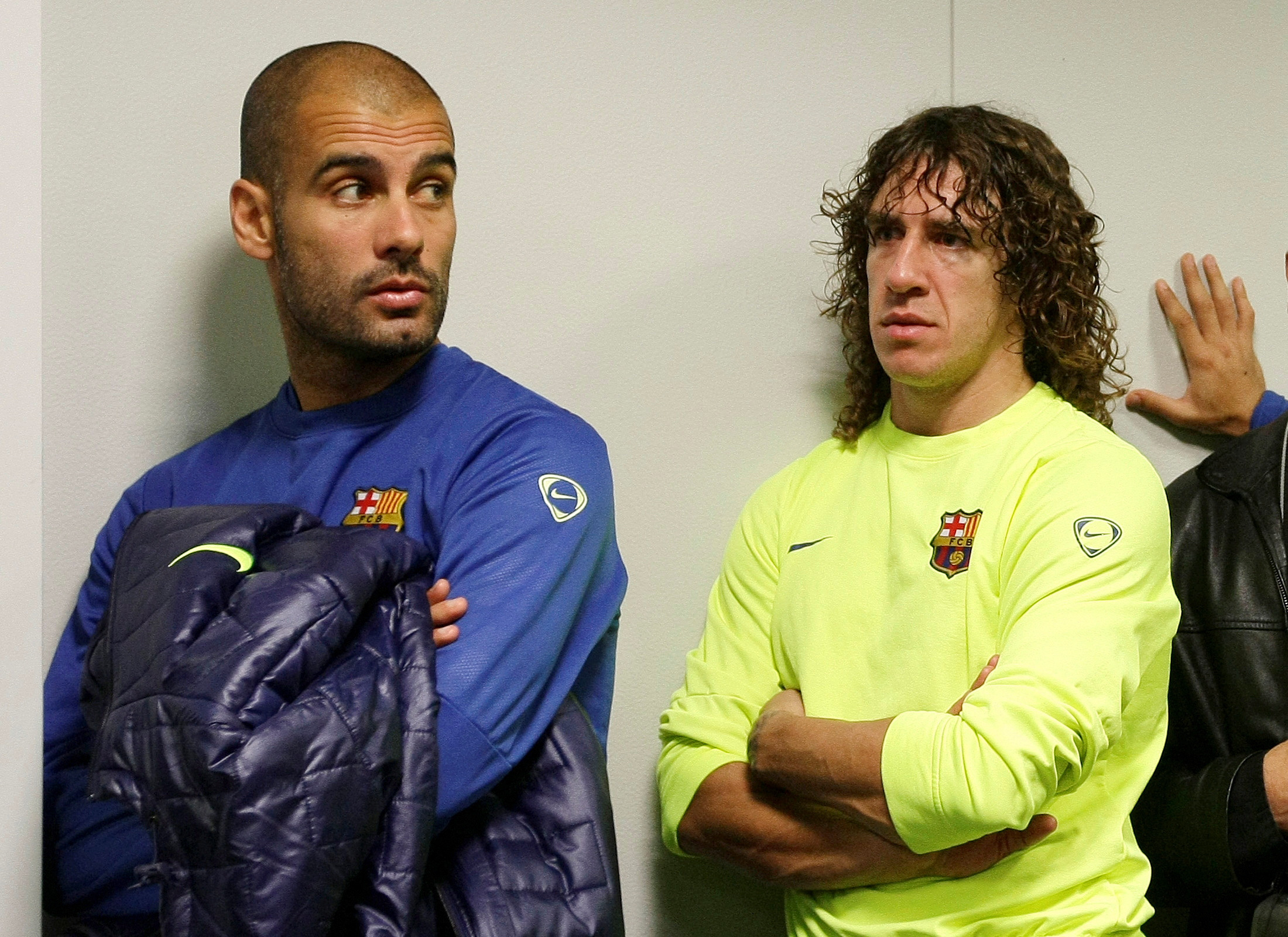 Barcelona's coach Guardiola gestures near captain Puyol in the news room during the presentation of a book of Barcelona's youth coach Puig in Sant Joan Despi