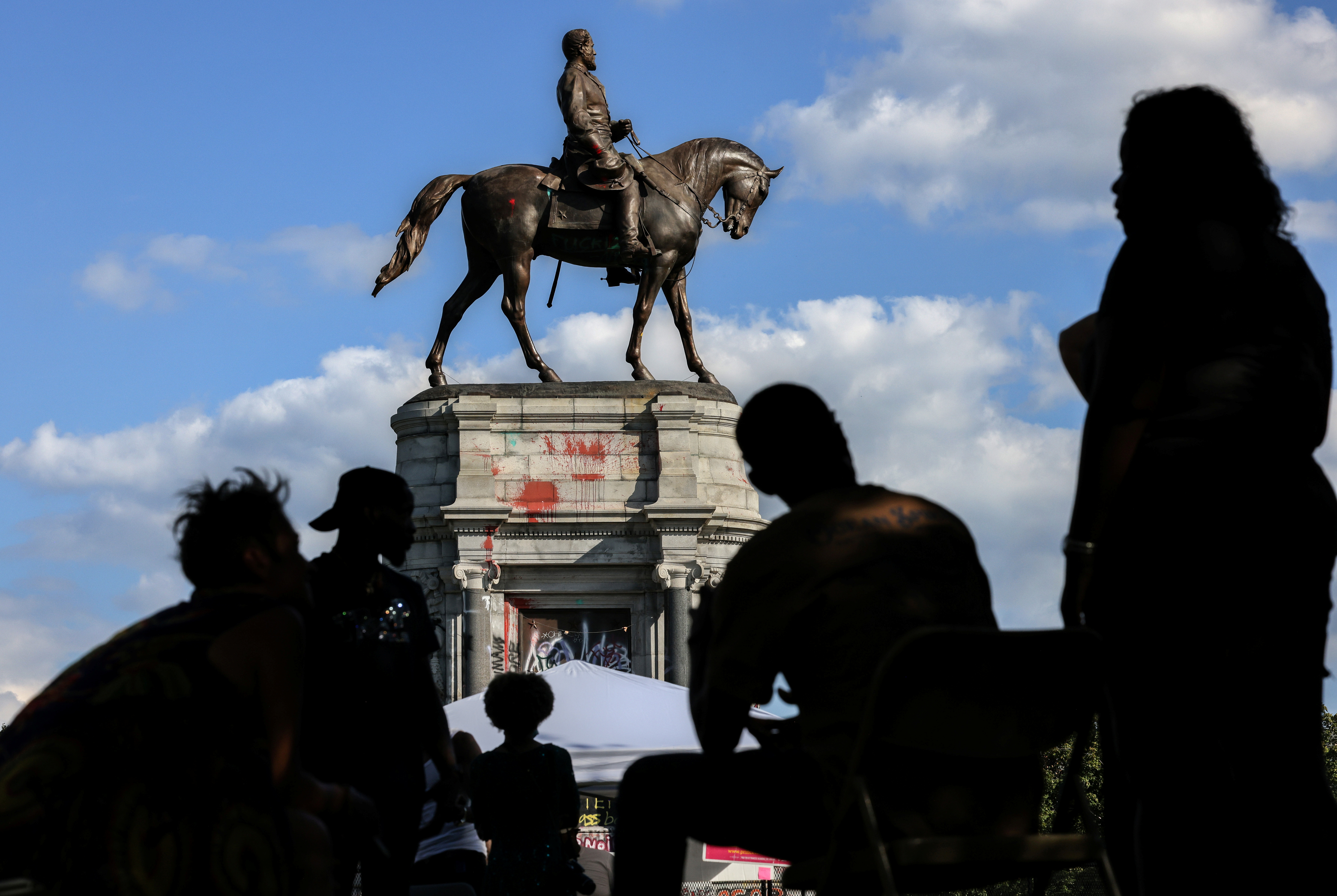 Richmond residents gather around the statue of Confederate General Robert E. Lee in Richmond