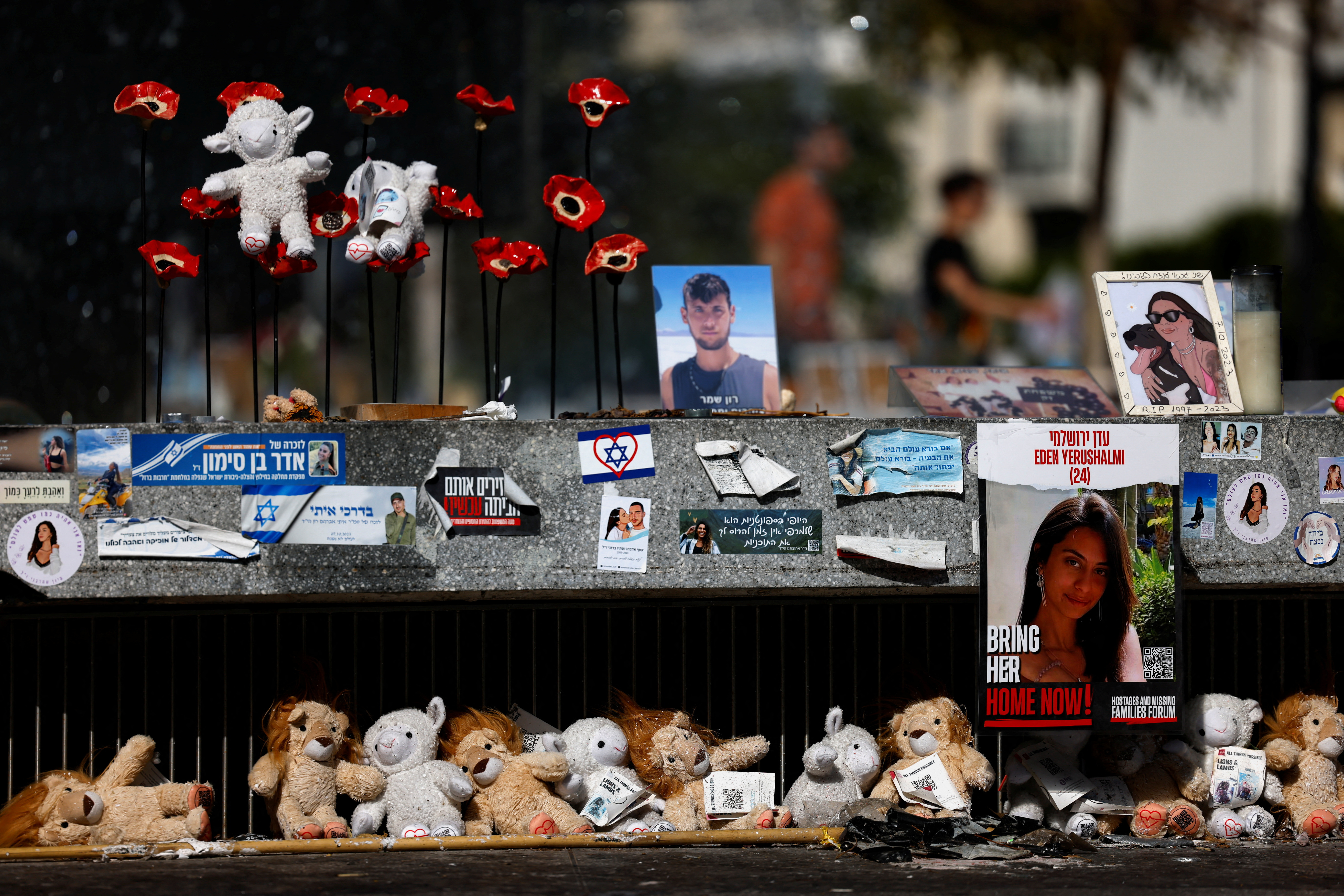 A woman looks at pictures of the hostages kidnapped on the deadly October 7 attack on Israel, in Tel Aviv