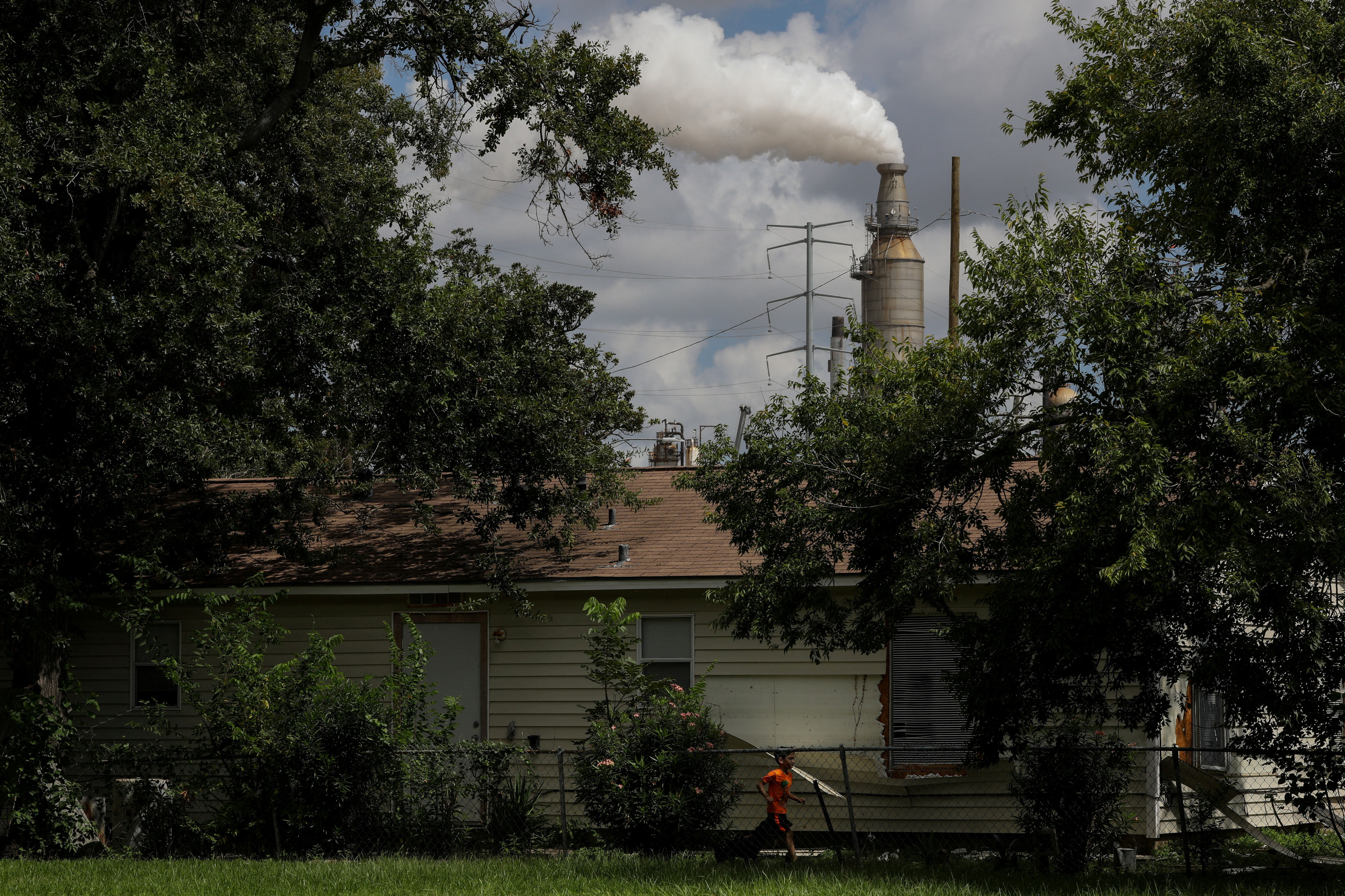 Child runs through the backyard of a home in the Manchester neighbourhood of Houston