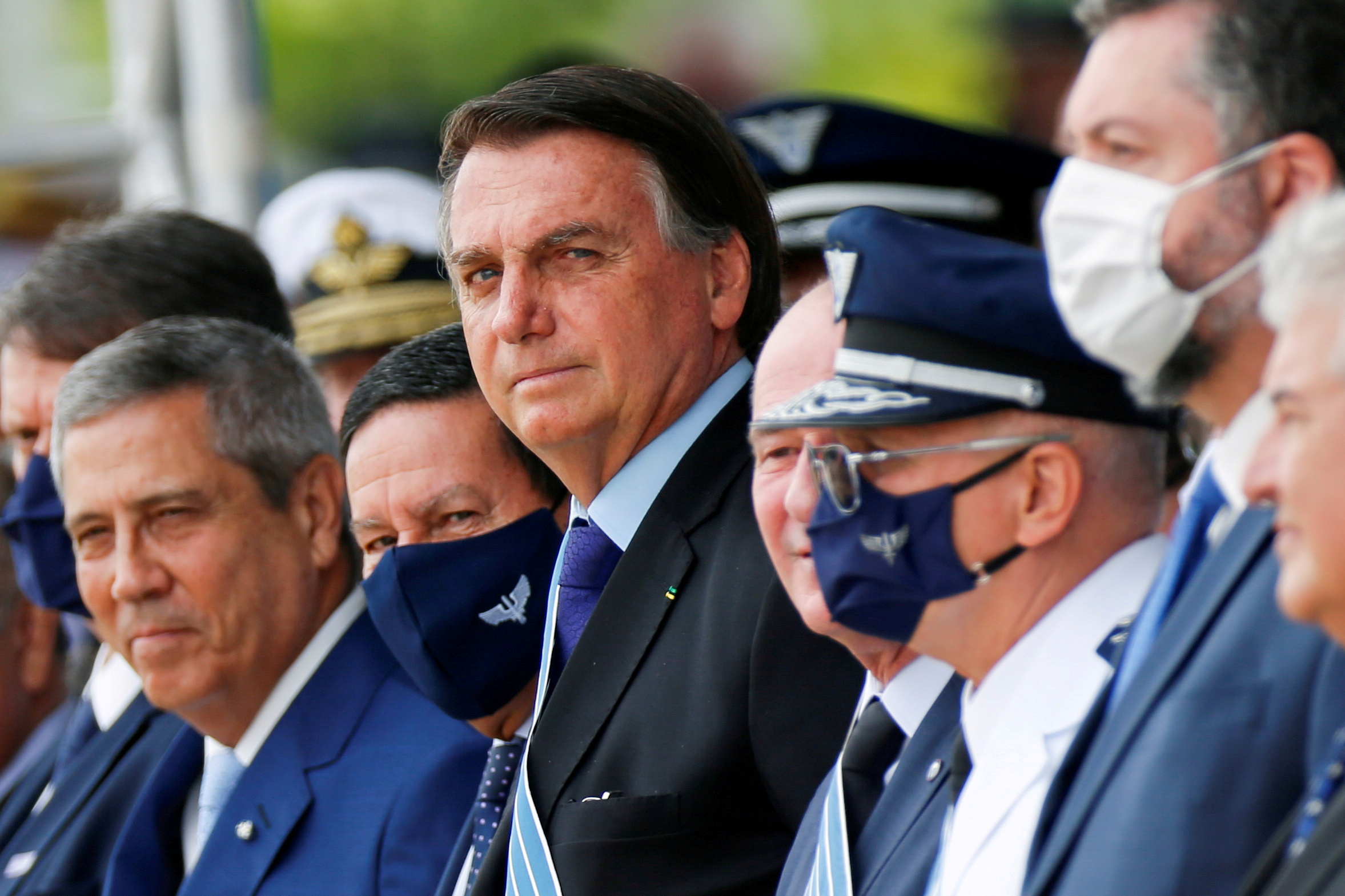 Brazil's President Jair Bolsonaro (C) looks on during a ceremony of Aviator's Day at Brasilia Air Base in Brasilia, Brazil October 23, 2020. REUTERS/Adriano Machado/File Photo