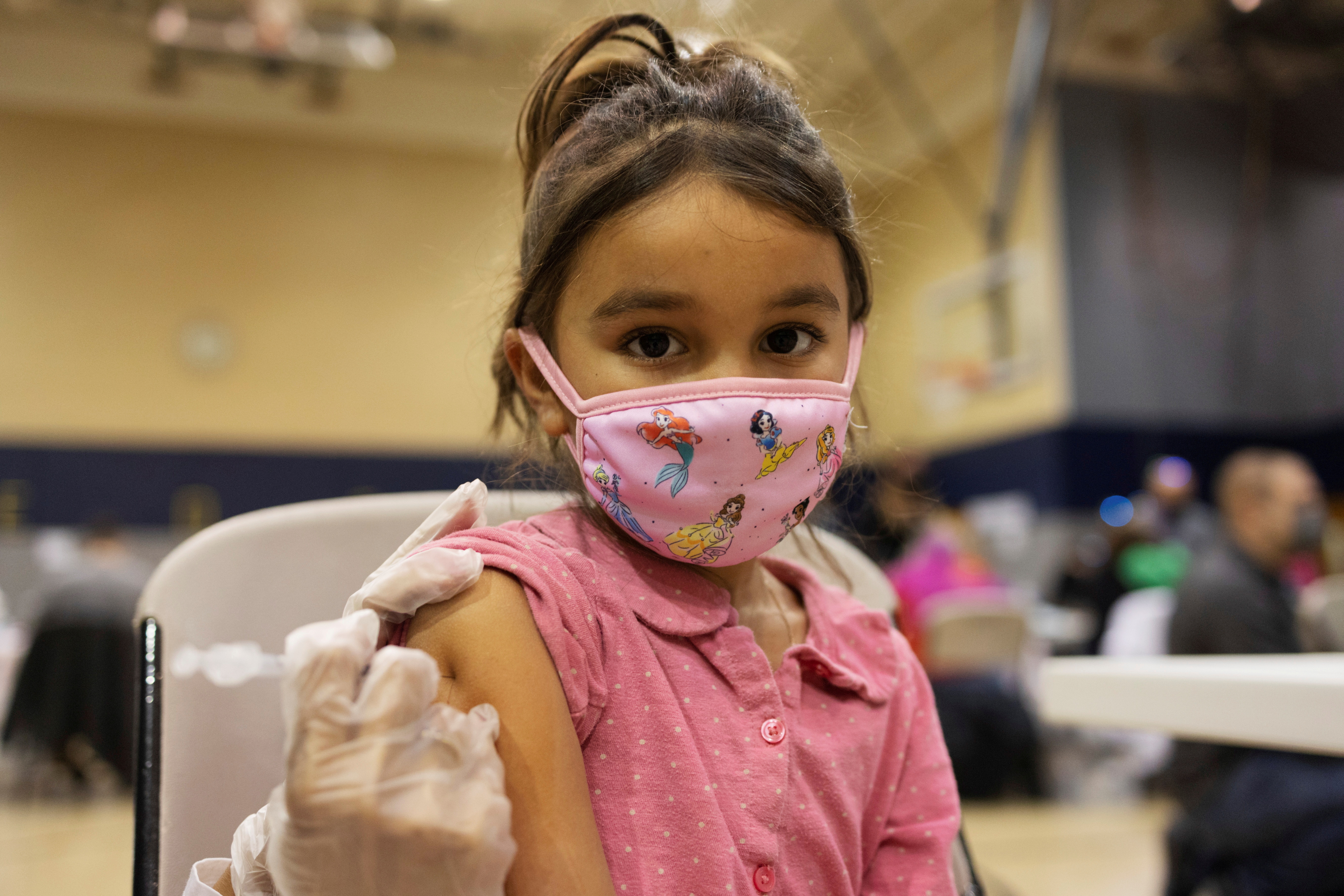 A girl receives the Pfizer-BioNTech coronavirus disease (COVID-19) vaccine in Lansdale, Pennsylvania, U.S., December 5, 2021. REUTERS/Hannah Beier