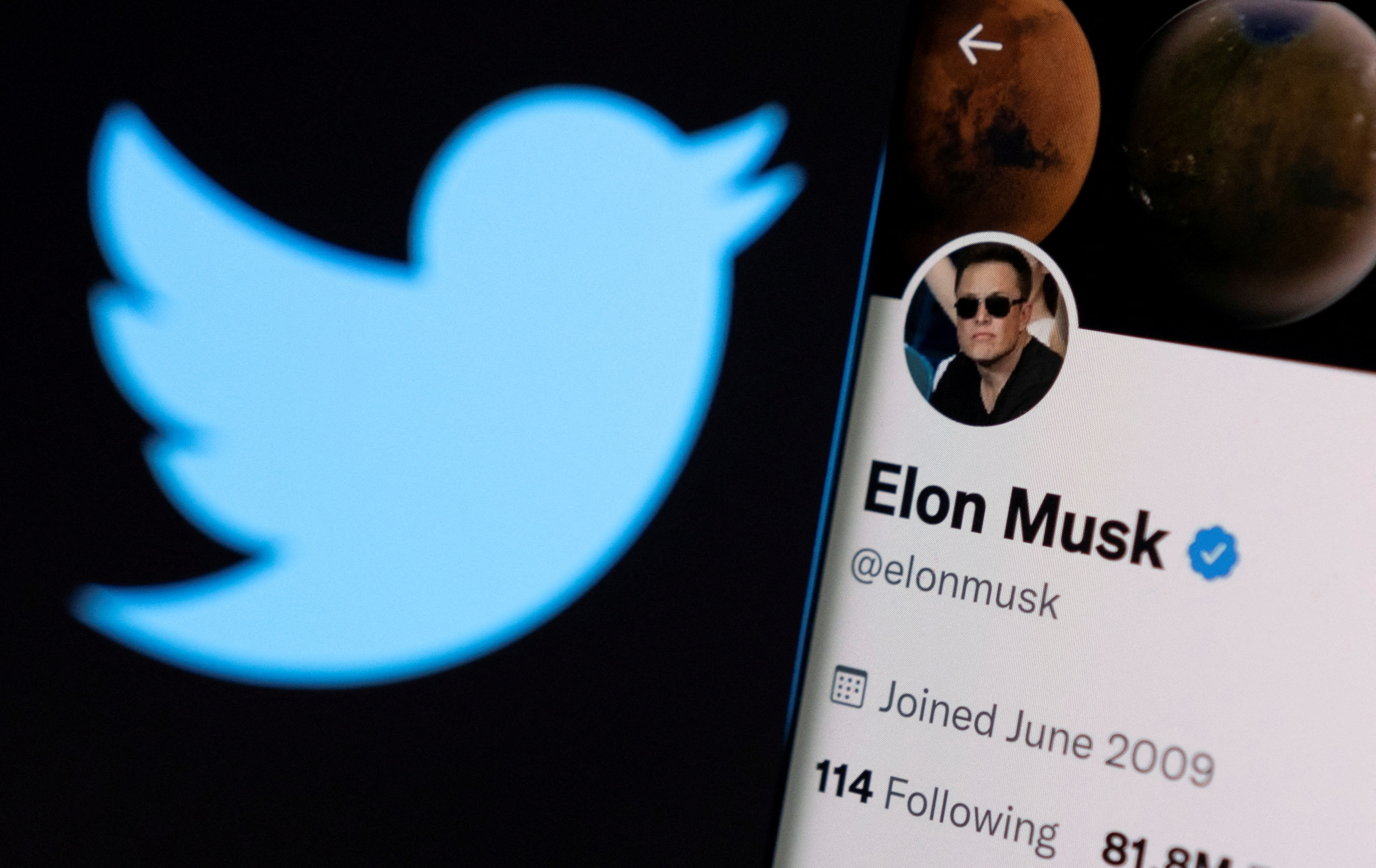 A photo illustration shows Elon Musk's twitter account and the Twitter logo