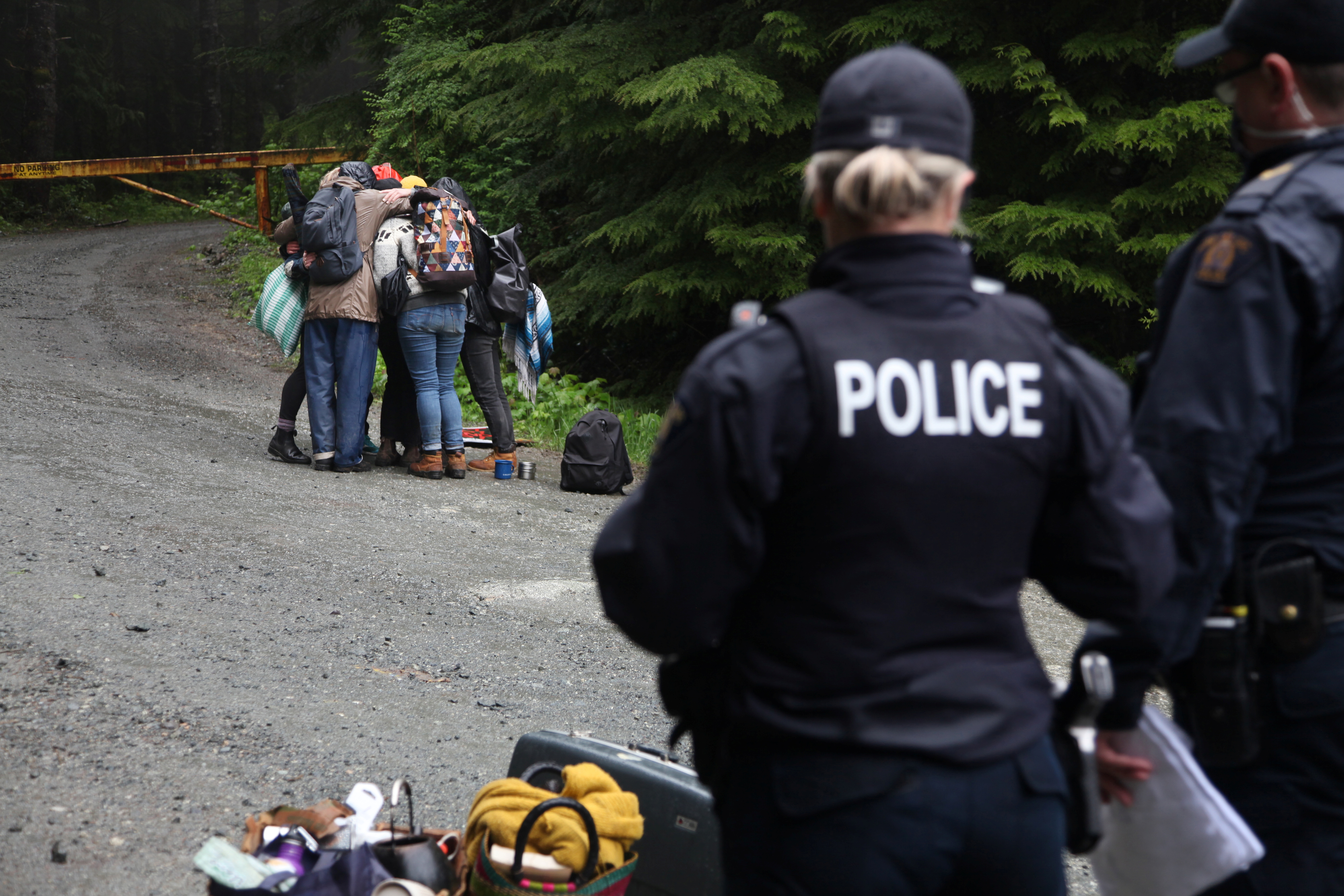 Protesters embrace at their blockade in the Fairy Creek area of Vancouver Island