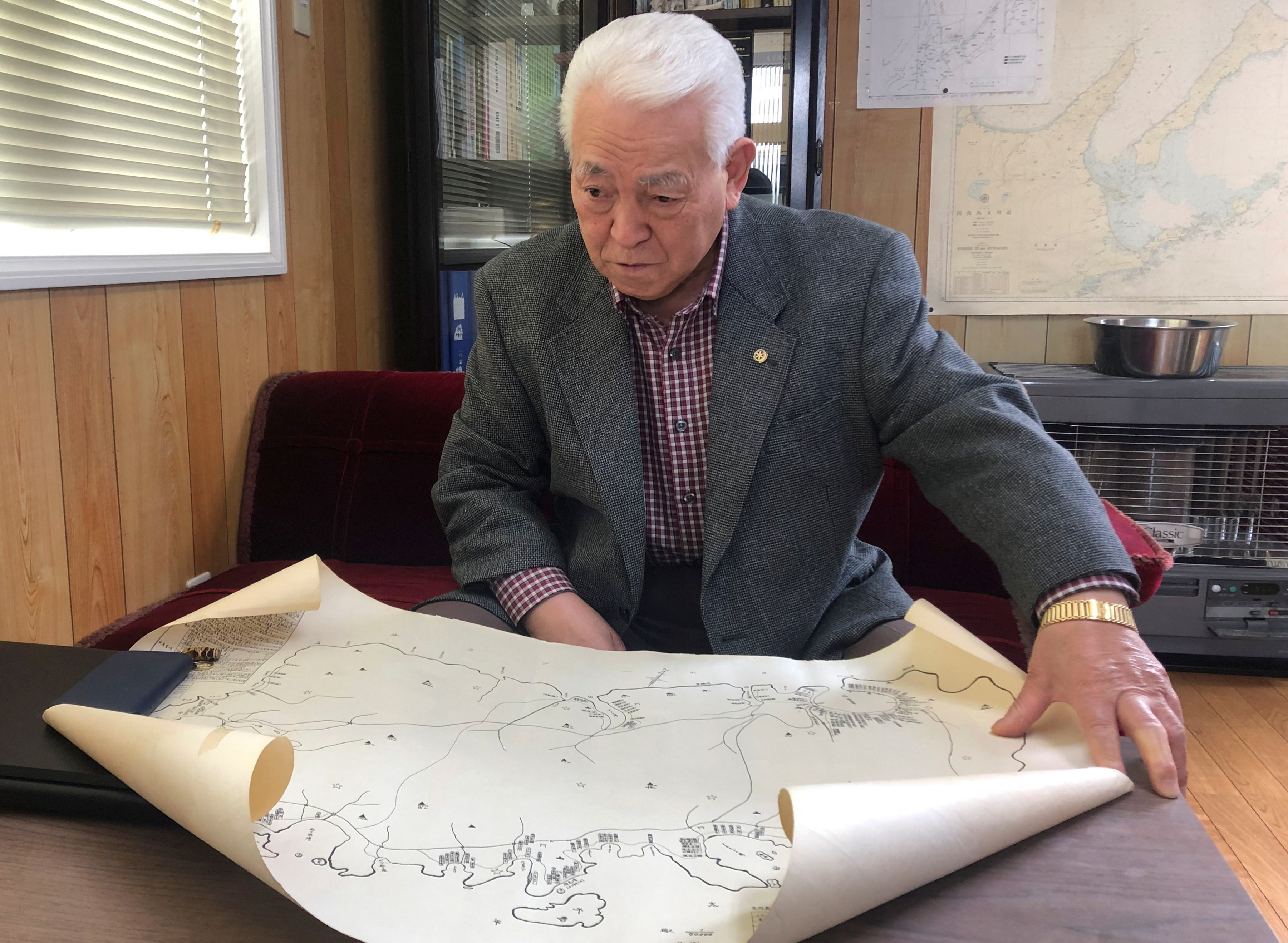 Tsuruyuki Hansaku shows a map of Shikotan island in Nemuro