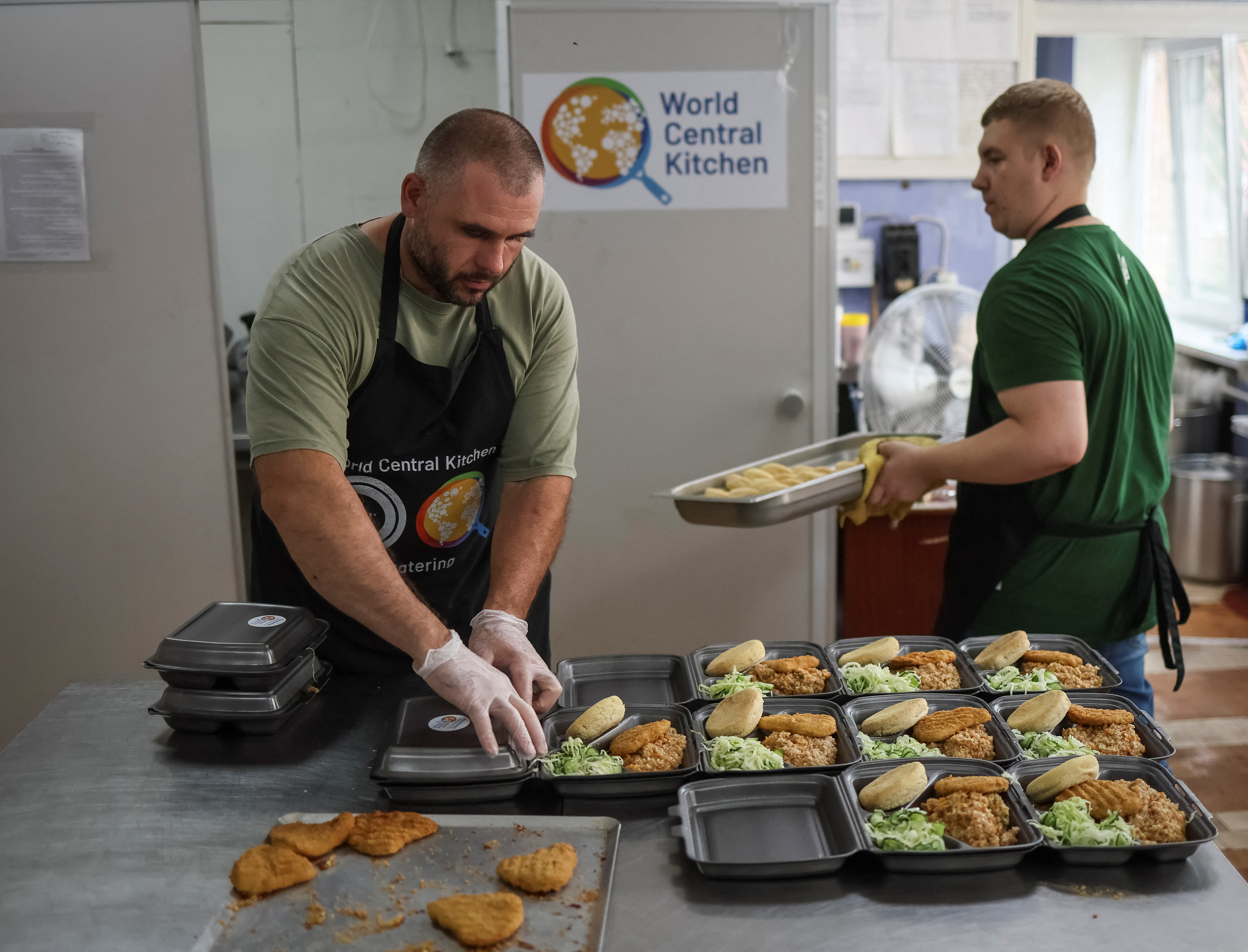 People receive a meal donated by World Central Kitchen, amid Russia's invasion of Ukraine, in Irpin