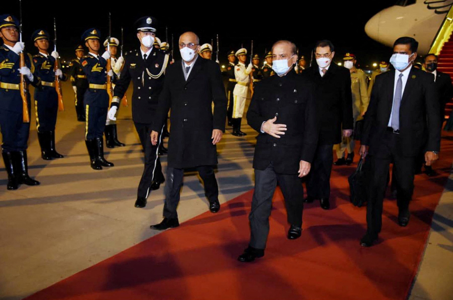 Pakistan's Prime Minister Shehbaz Sharif, walks past honour guards upon his arrival in Beijing