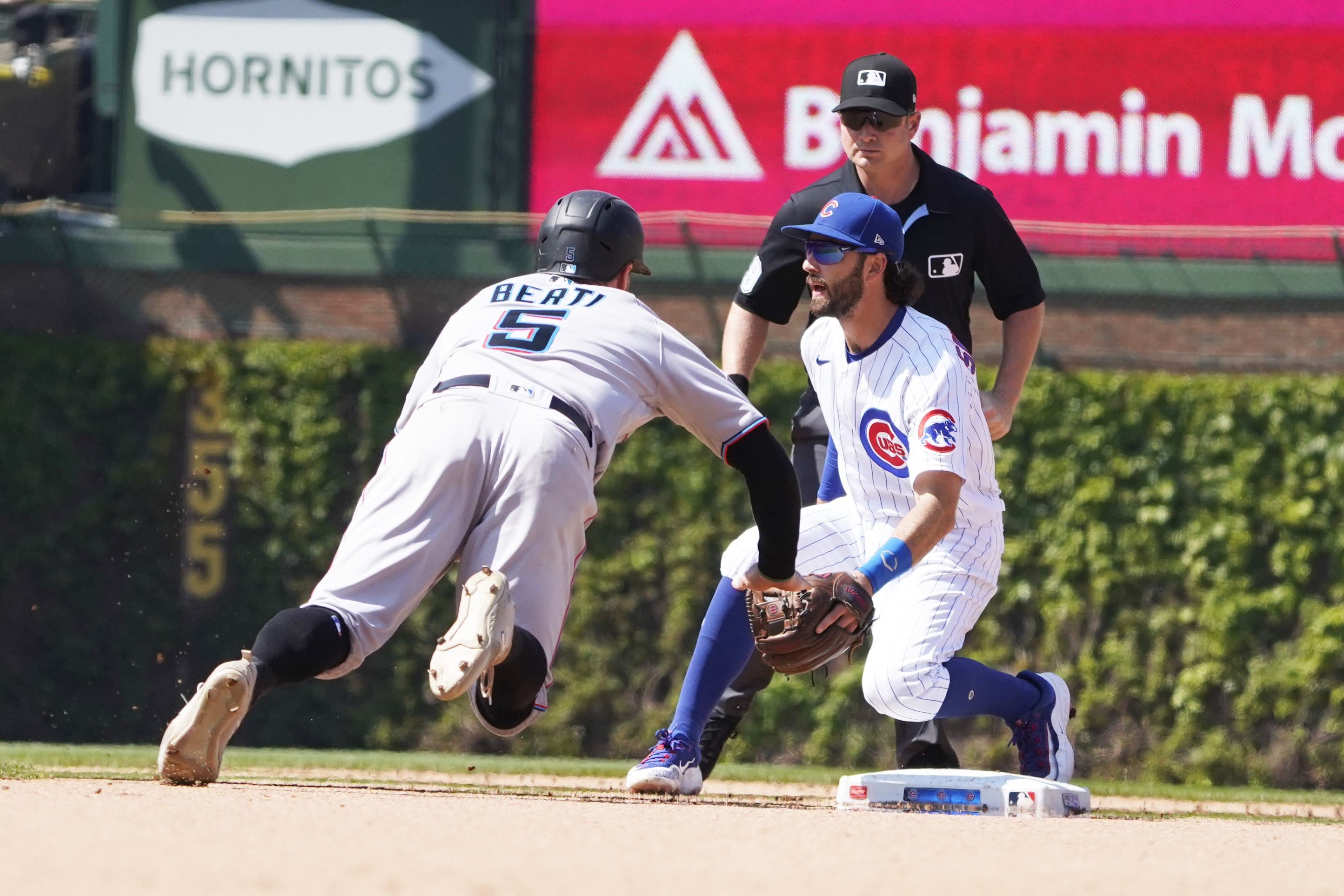 Chicago Cubs starting pitcher Adbert Alzolay is congratulated in the dugout  after pitching a scoreless eighth inning against the Miami Marlins during a  baseball game Tuesday, Sept. 20, 2022, in Miami. The