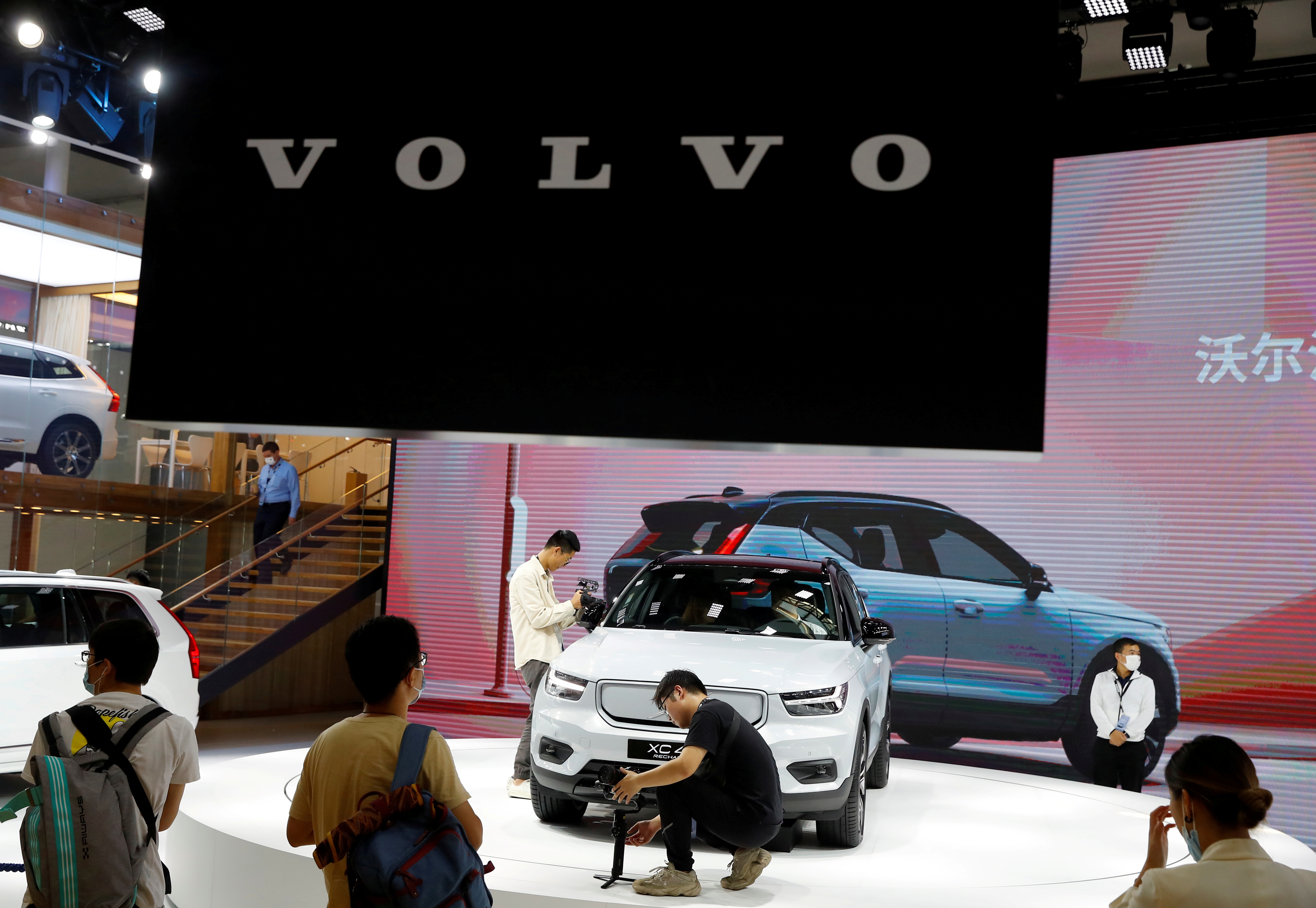 People look at a Volvo XC40 car during the Beijing International Automotive Exhibition, or Auto China show, in Beijing, China September 26, 2020. REUTERS/Thomas Peter/File Photo