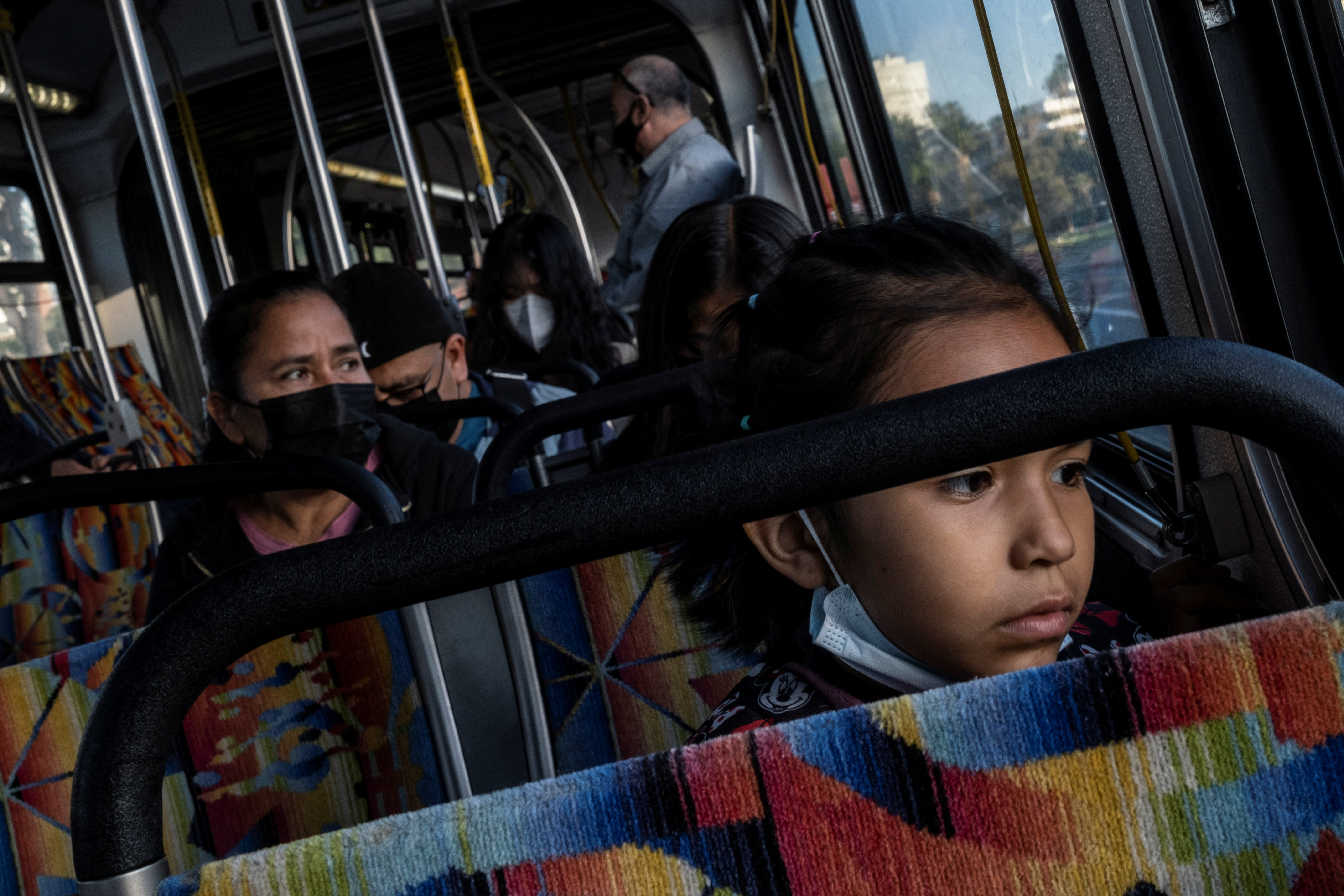 Maria Hernandez and her daughters travel on a bus after her reunification with them in Los Angeles