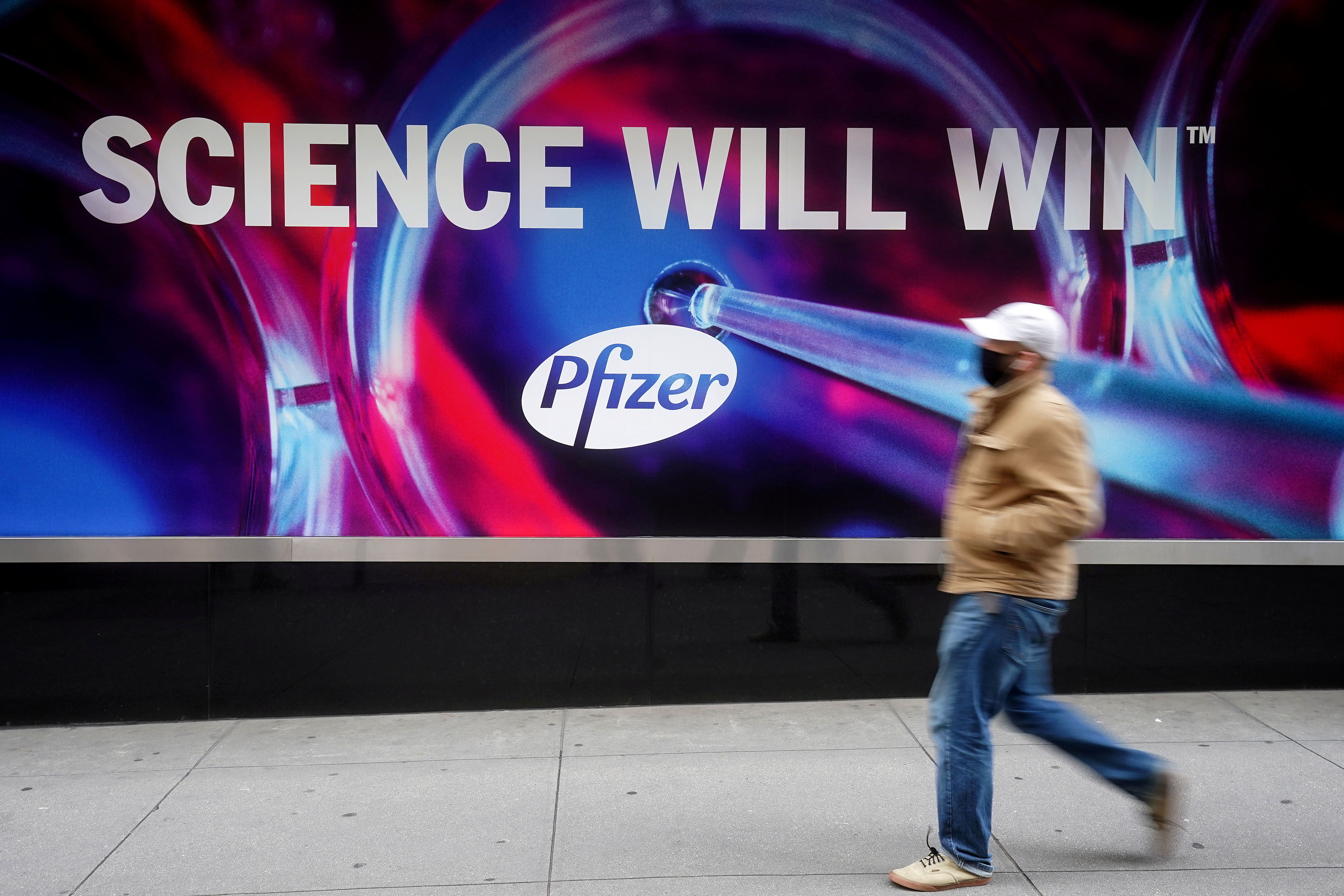 A person walks past the Pfizer Headquarters building in New York City