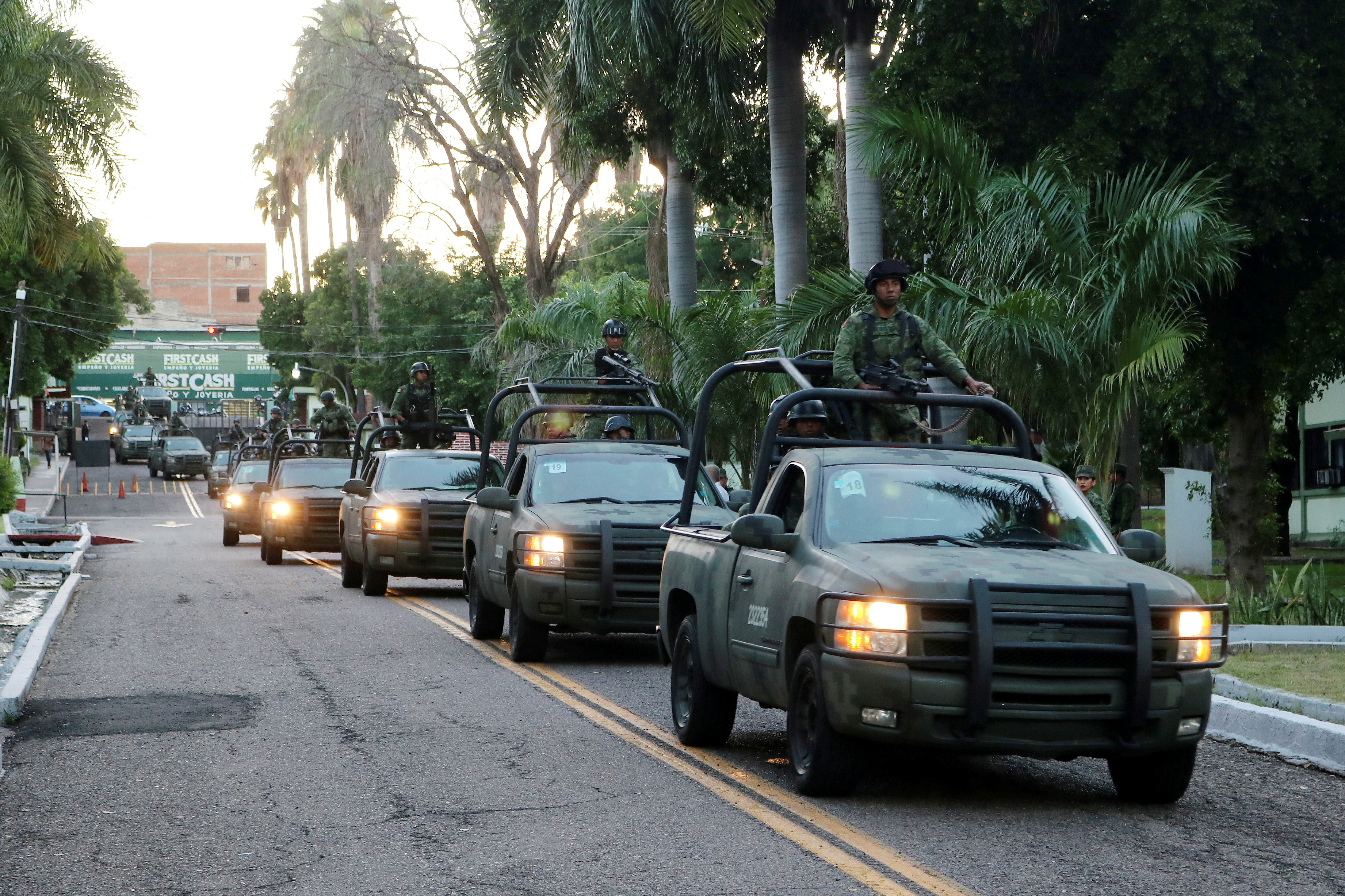 Members of a special unit of the Mexican Army leave a military zone to patrol as part of an operation to increase security after cartel gunmen clashed with federal forces in Culiacan