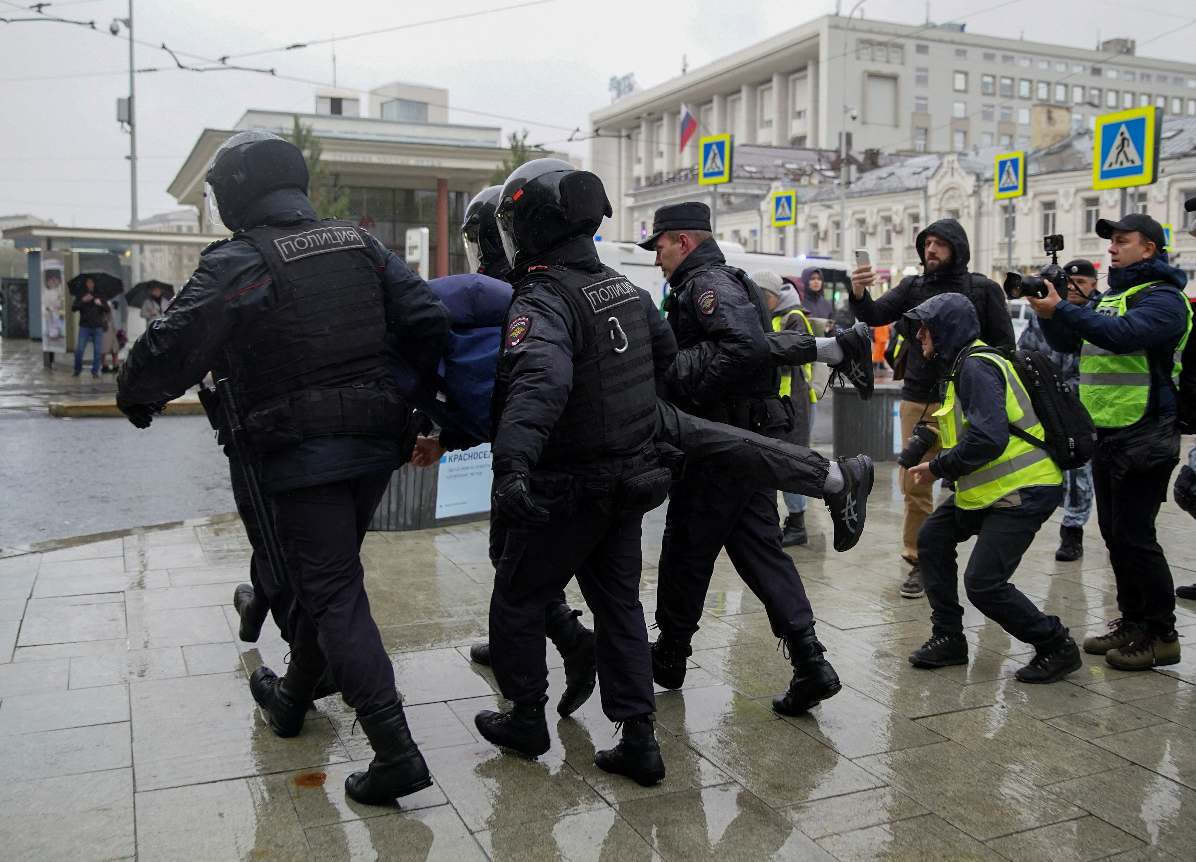 Russian police officers detain a person during a rally in Moscow