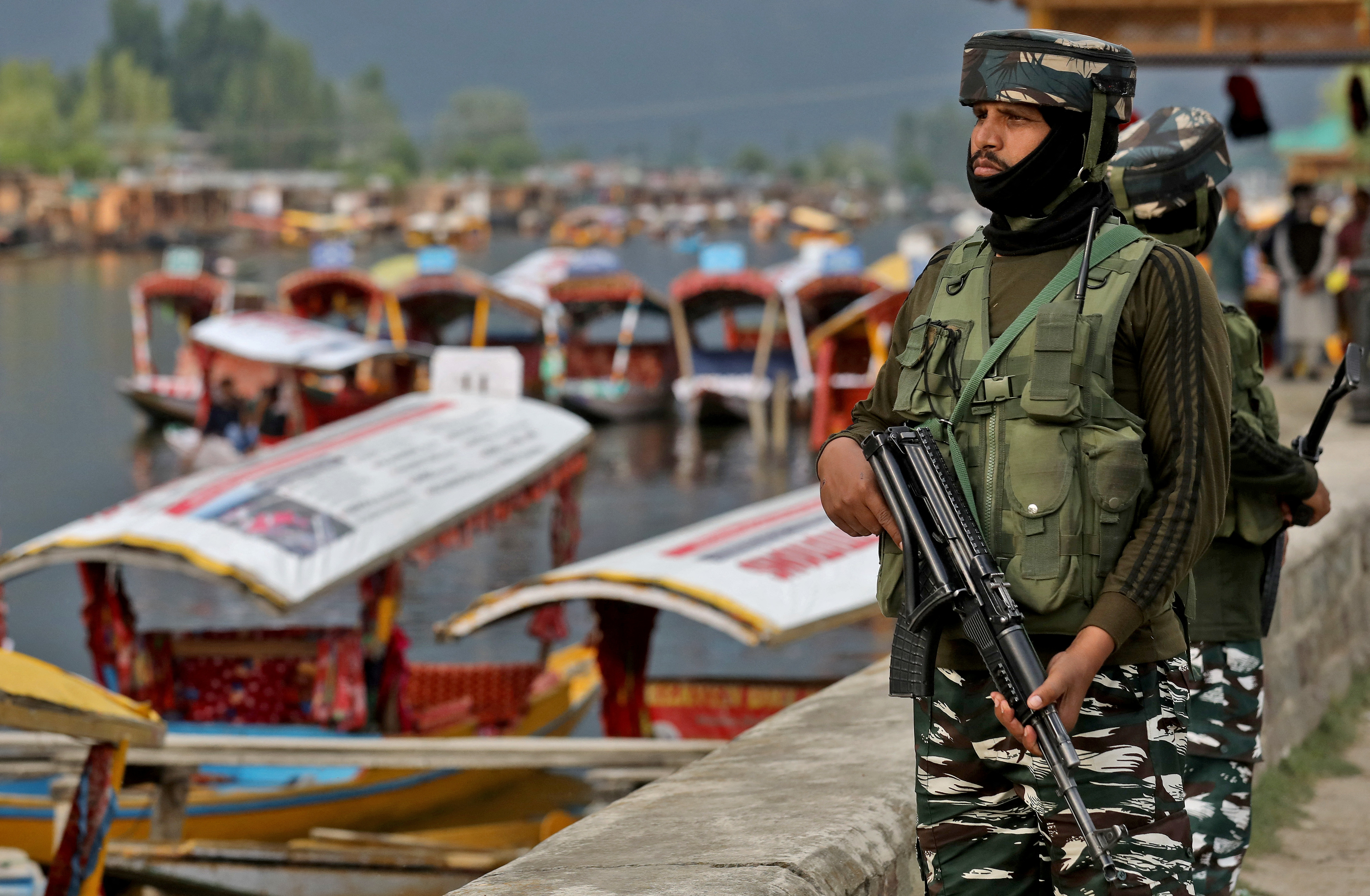 India's Central Reserve Police Force personnel stand guard on the banks of Dal Lake in Srinagar