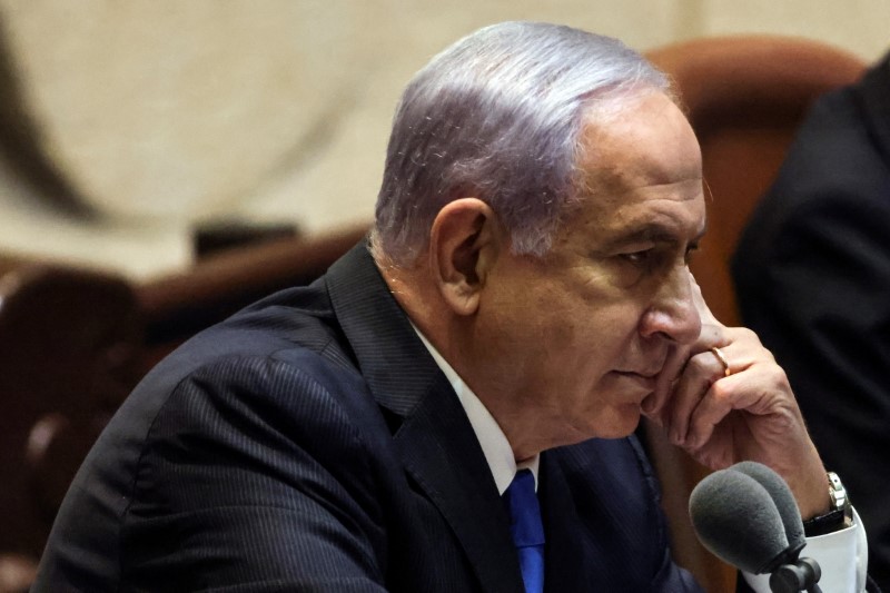 Israeli Prime Minister Benjamin Netanyahu looks on as he delivers a speech during a special session of the Knesset, Israel's parliament, to approve and swear-in a new coalition government, in Jerusalem