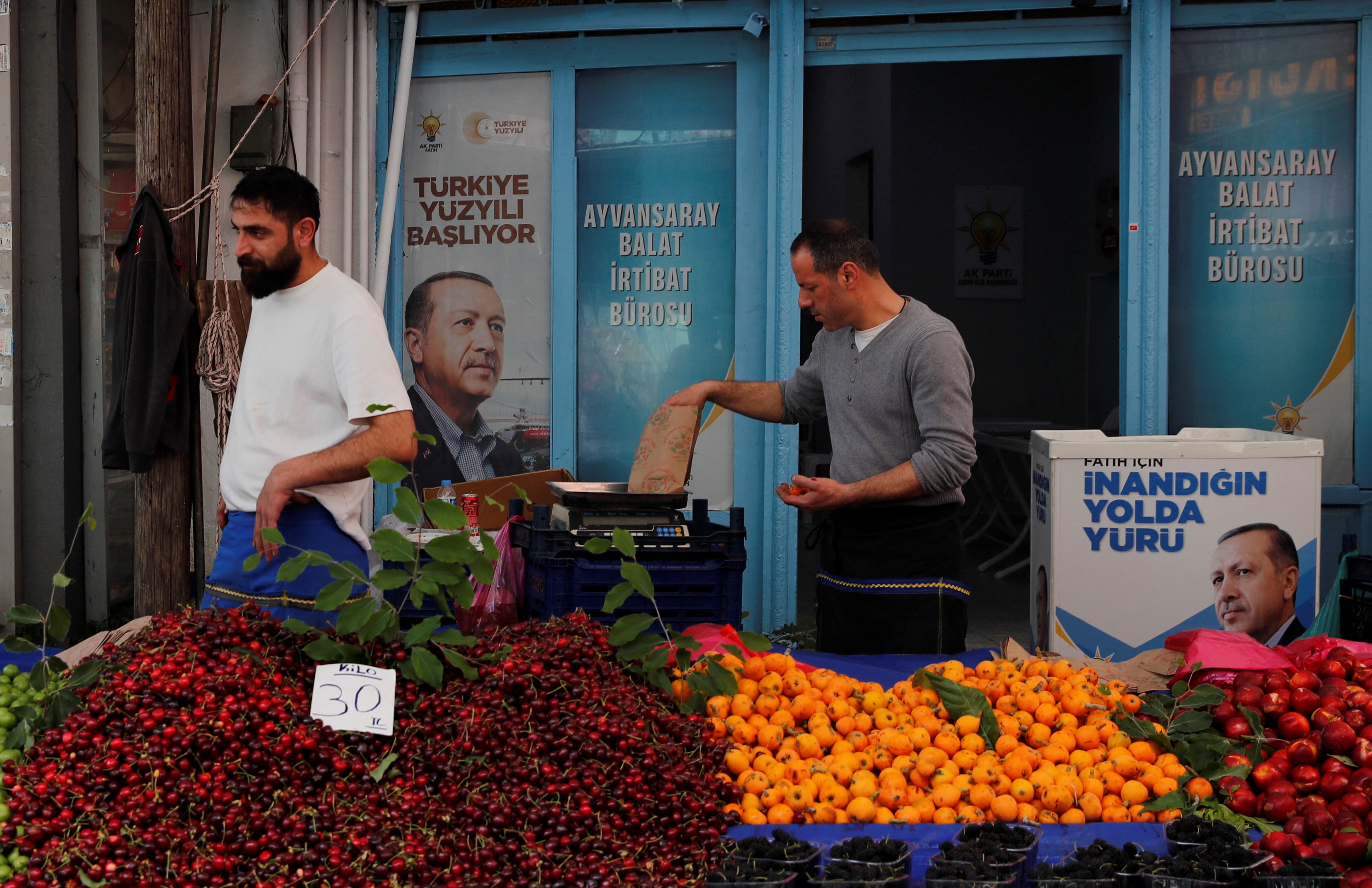 Vendors stand in their stall at a fresh market in Istanbul